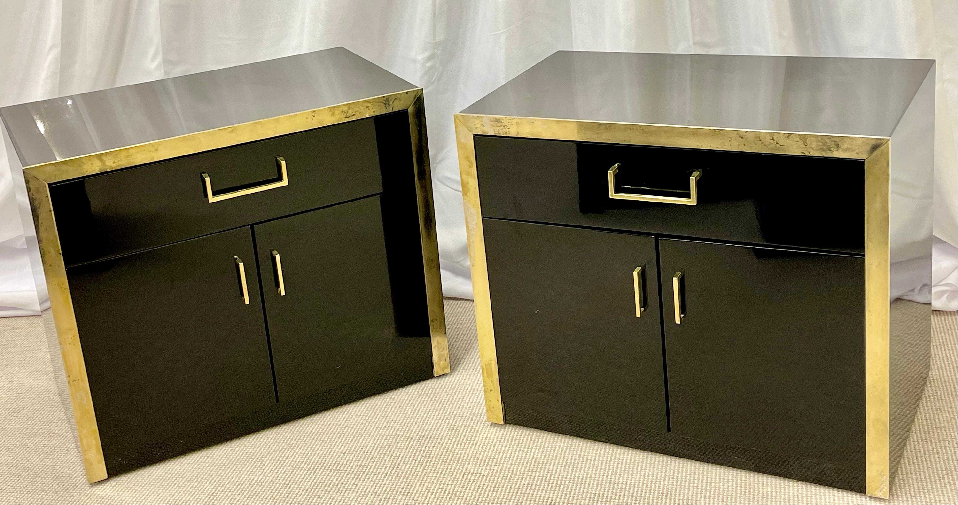 Pair of Mid Century Modern nightstands in the Milo Baughman Fashion each having a single drawer over double drawers leading to a finished interior. The exterior having recently been black lacquered with a brass distressed frame and brass pulls. We