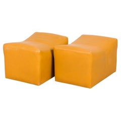 Vintage Pair of Milo Baughman Mustard Yellow Leather Rolling Saddle Ottomans