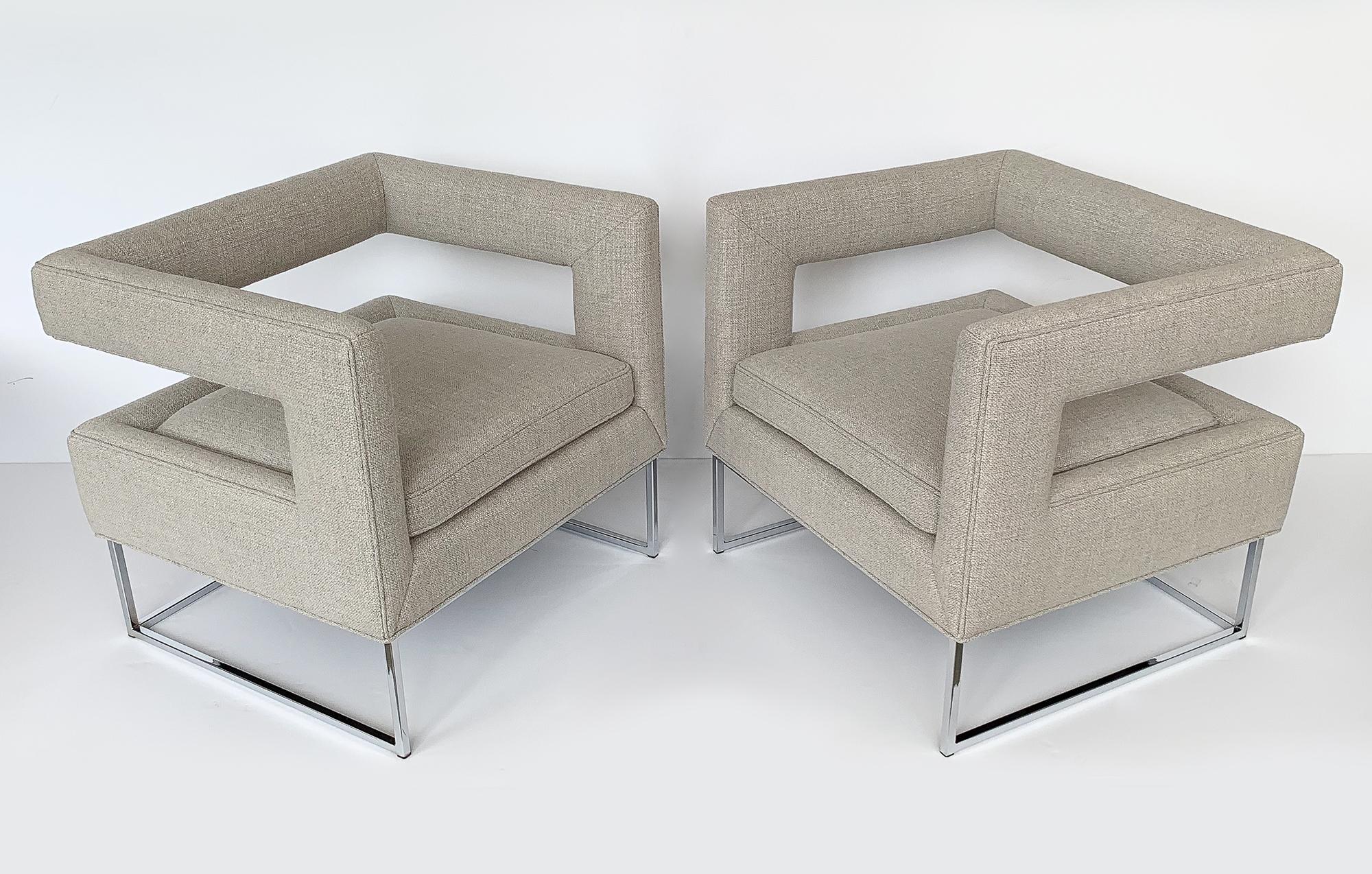 Striking pair of Milo Baughman open back lounge chairs, circa 1970s. These cube shaped chairs are newly upholstered in a sophisticated pale gray-beige textured woven fabric. All new foam throughout. Loose seat cushion. Chrome-plated square tubular