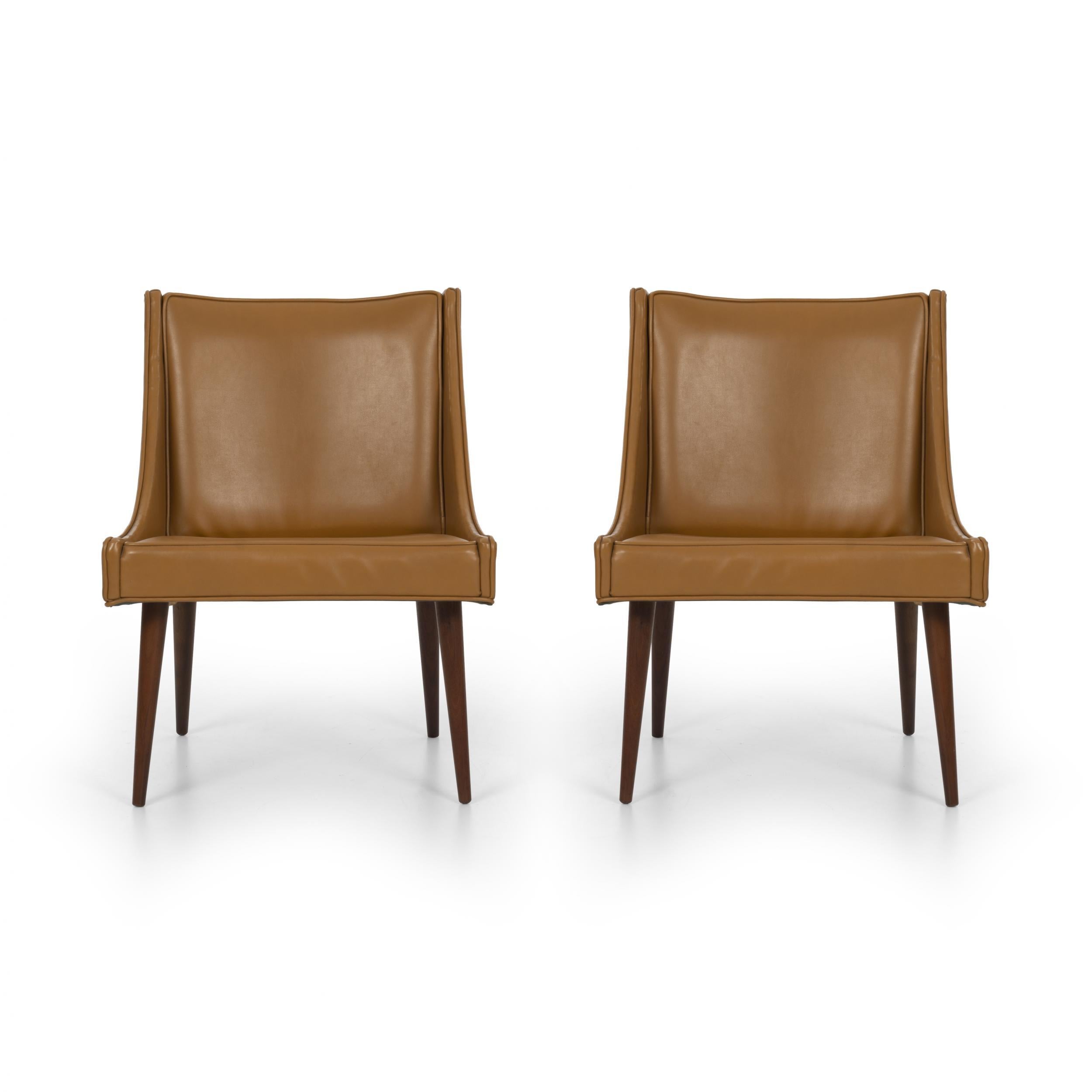 Pair of Milo Baughman slipper chairs for Thayer Coggin, original vinyl upholstery with solid turned walnut legs.
(Multiple labels on underside).