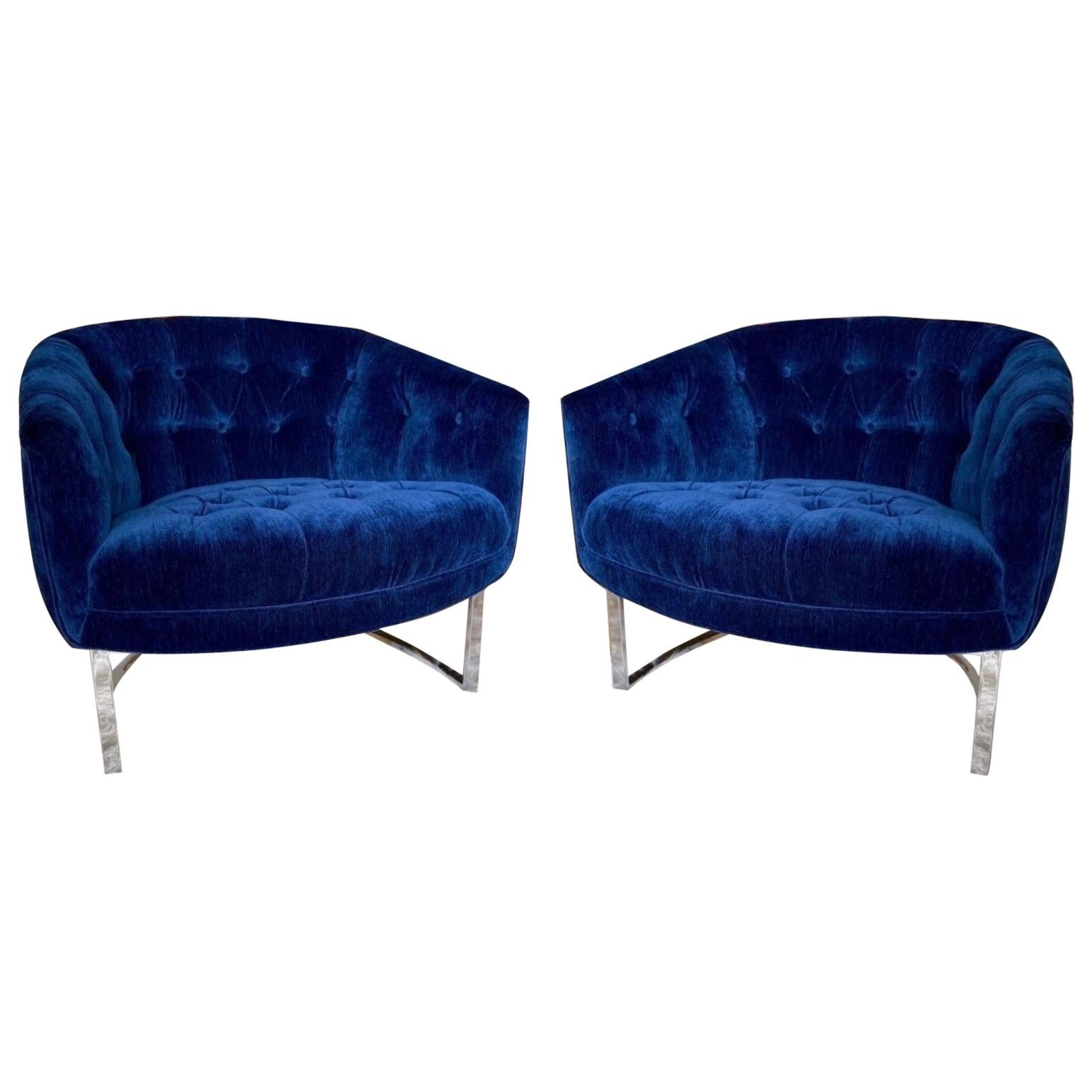 Simple design with wonderful proportions offered is a pair of Milo Baughman style chromed steel flat framed armchairs, circa 1970s. The tufted upholstered floating tub seats are supported with chromed steel bases that curve delicately around the