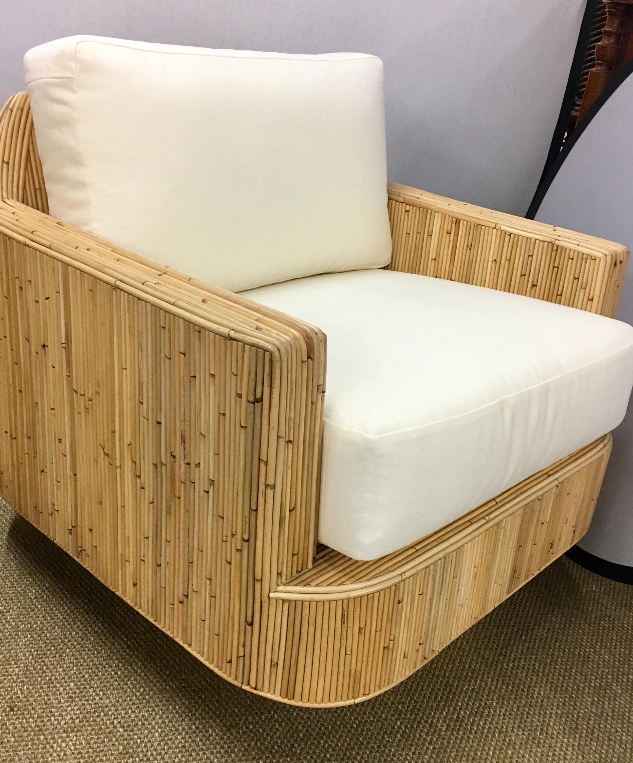 Vibrant matching pair of Baughman style cased swivel chairs on round base.