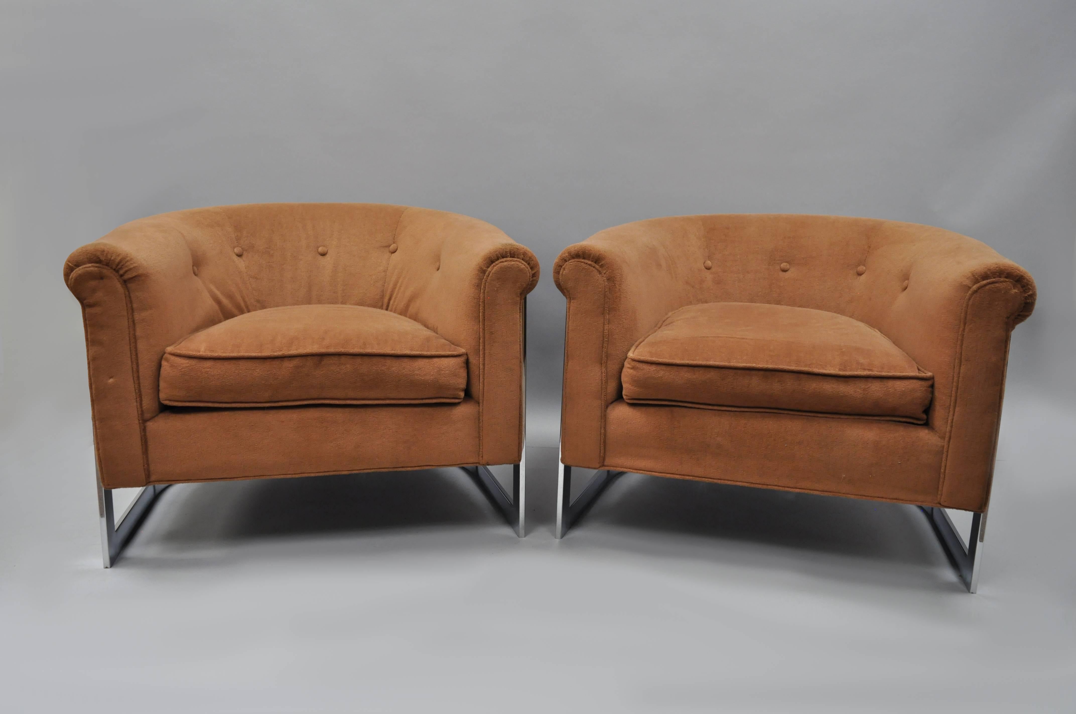 Pair of vintage Mid-Century Modern Milo Baughman style chromes barrel back club chairs. Chairs feature low sleek forms, chrome frames with chrome support down the rear, rolled backs, and clean modernist lines.