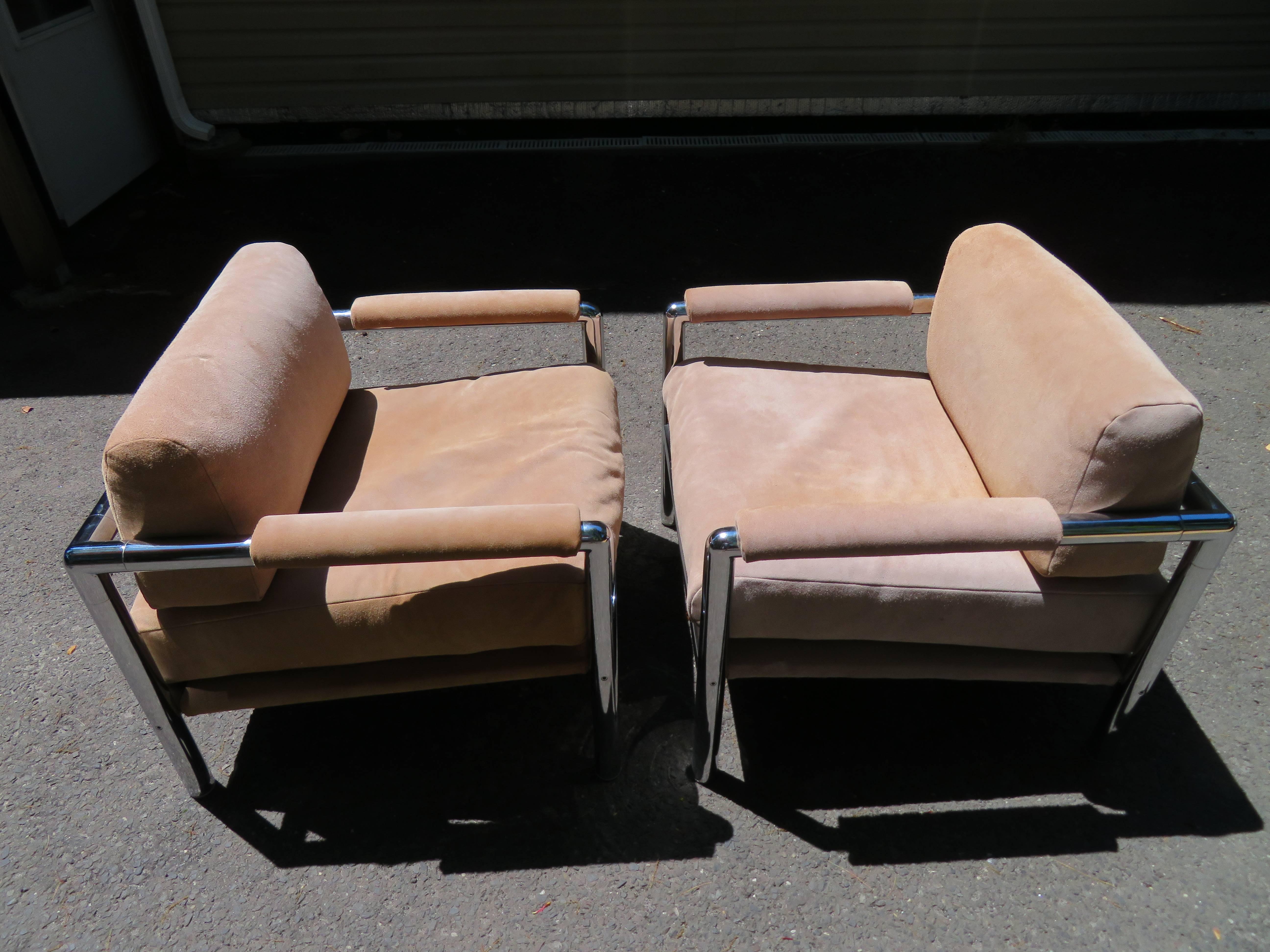 Magnificent pair of Milo Baughman style heavy chrome lounge chairs, circa 1970s. This pair are quite unique with chunky round bars making the frame instead of the usual flat bars. The upholstery is original and is a tan suede-still in usable