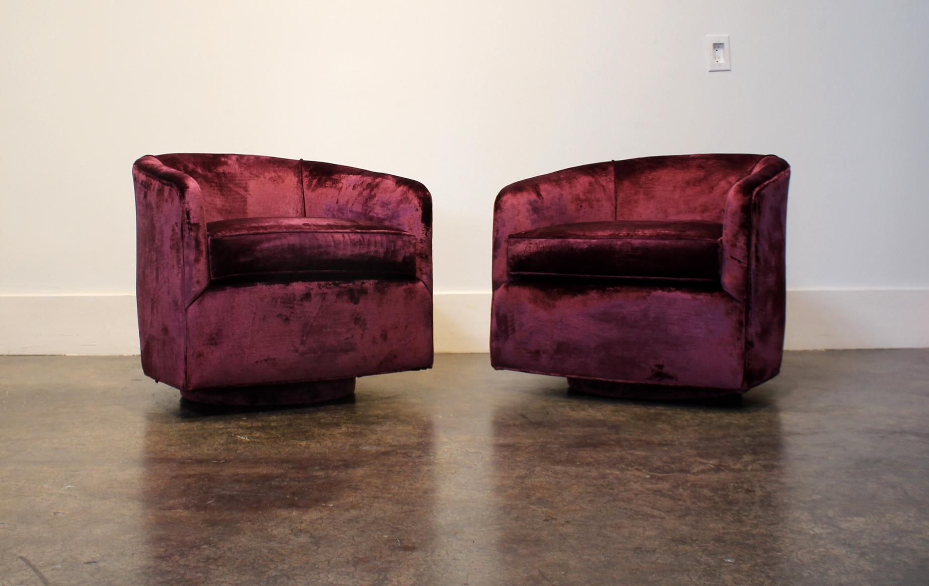 Pair of vintage Baughman-style swivel club chairs in purple/burgundy velvet. Chairs are from 1970s-1980s and are sturdy and function smoothly. Upholstery is recent and in good condition.