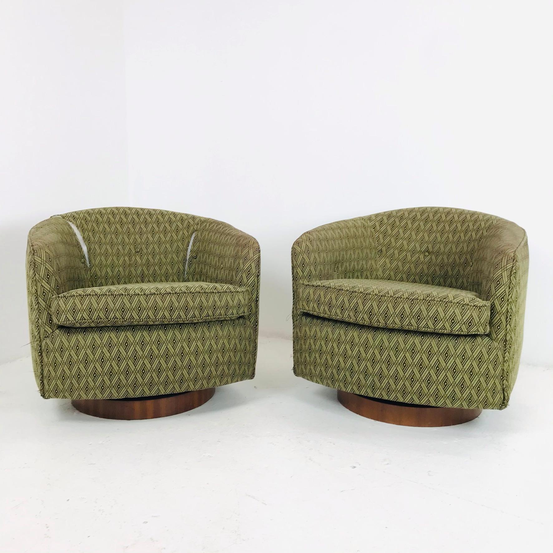 Beautiful pair of swivel chairs designed by Milo Baughman. Each chair has a circular wood plinth base that swivels with ease. Elegant in design, the chairs are also extremely comfortable, offering wonderful back support. Good structural condition -