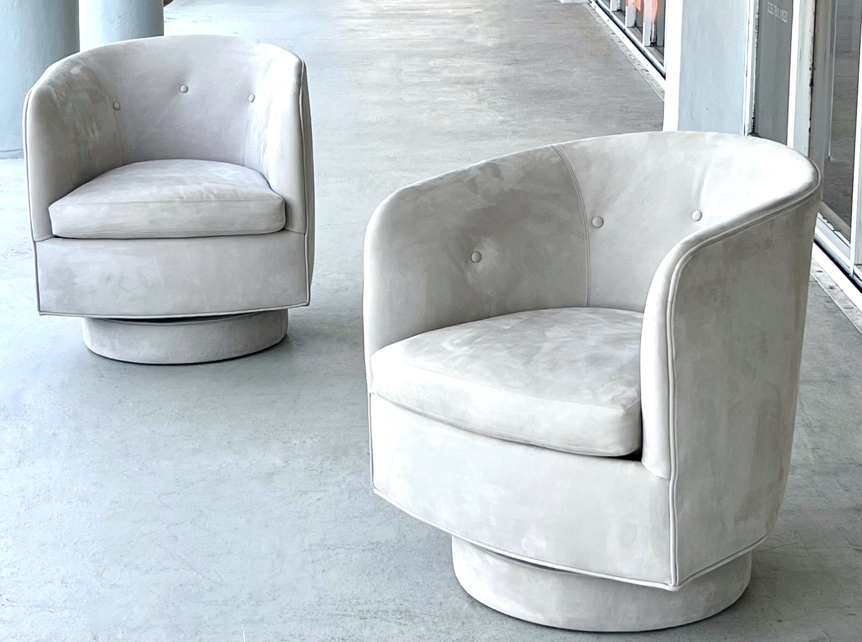 This pair of Milo Baughman swivel chairs in nubuck leather combines iconic mid-century modern design with soft plush upholstery.  On Thayer Coggin tilt and rock swivel bases. 

2 pairs available. 