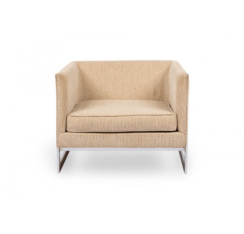 Pair of American Mid-Century floating cube form lounge / armchairs with chrome plated metal frames and textured beige upholstery. (MILO BAUGHMAN FOR THAYER COGGIN)(PRICED AS Pair)

One chair has a small hole in the upholstery on the back left side.
