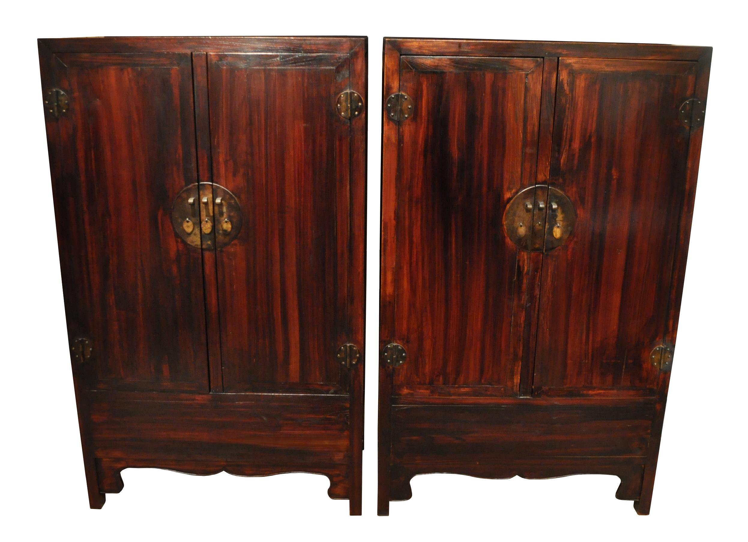 A handsome pair of Ming style early 20th century wedding cabinets 
of traditional mitered mortise and tenon construction,
the fronts of the cabinets have matching pearled edge aprons and brass lotus petal pulls on attractive circular brass face