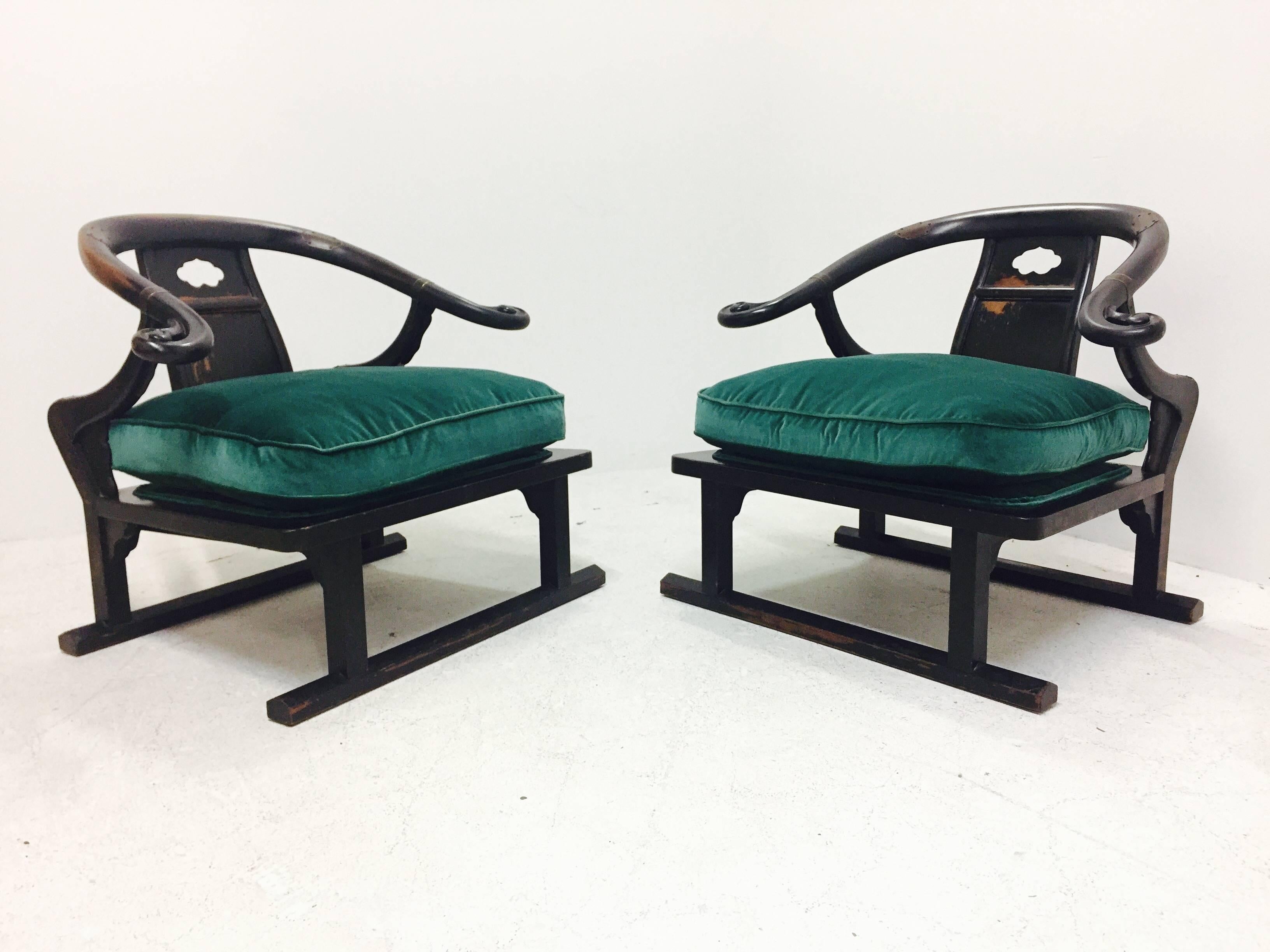 Pair of Ming Style lounge chairs. These chairs retain the warm patina of the wood and cushions have been re-upholstered in deep green velvet.

Dimensions: 31