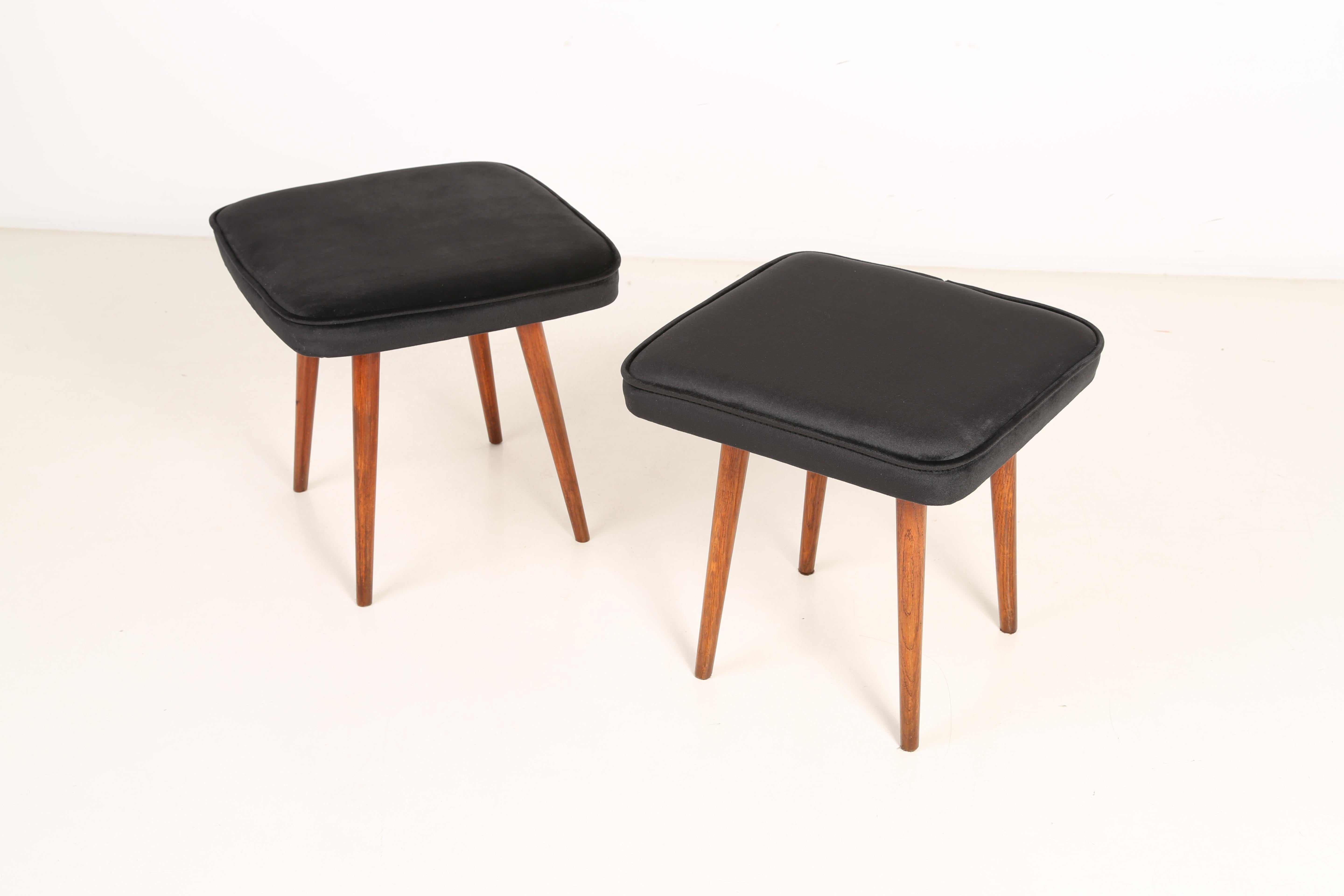 Stool from the turn of the 1960s and 1970s. Beautiful black velvet upholstery. The stool consists of an upholstered part, a seat and wooden legs narrowing downwards, characteristic of the 1960s style. We can prepare this pair also in another color