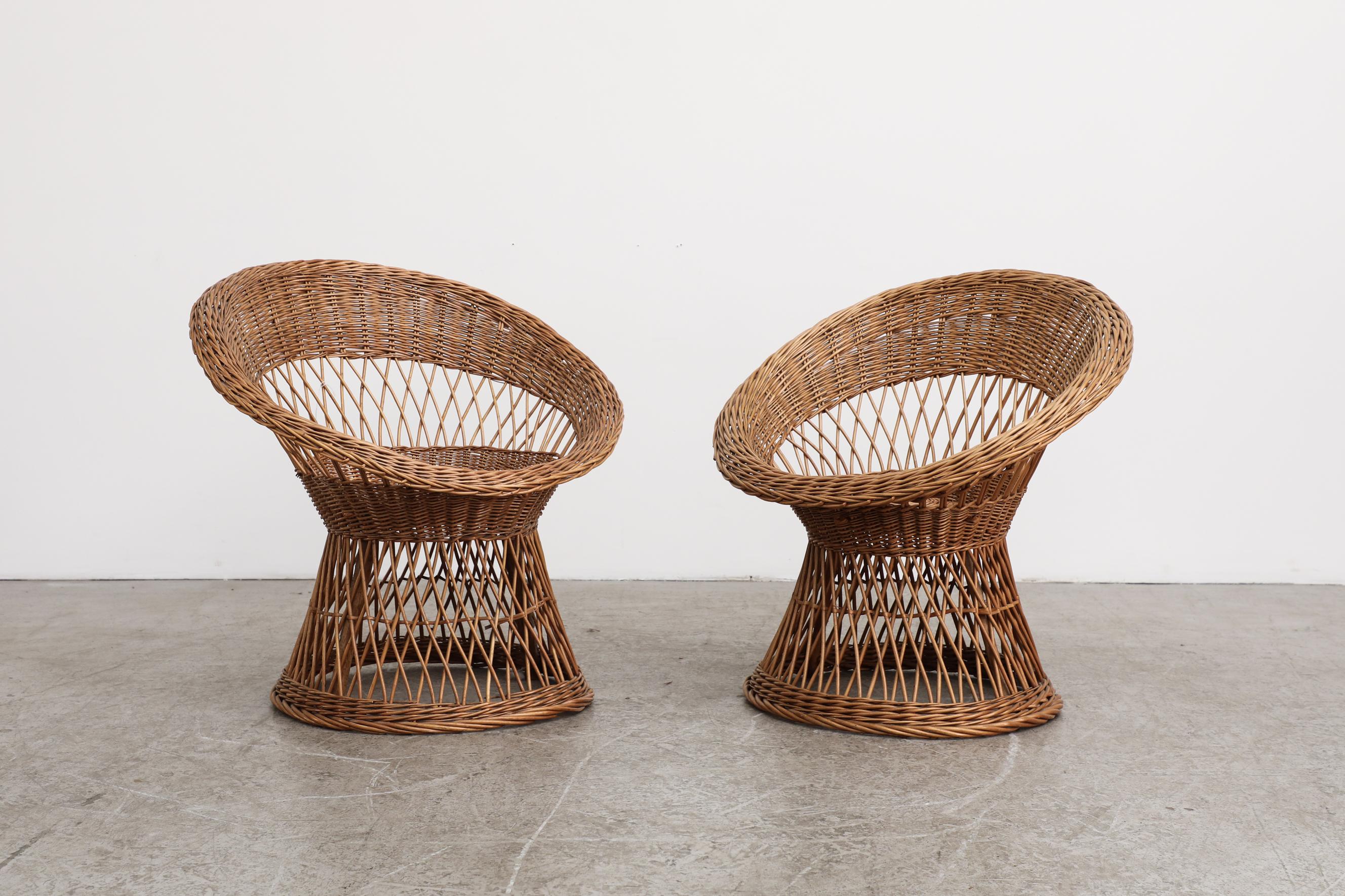 Pair of round, mid-century, mini peacock chairs hand made from woven rattan. In original condition with visible wear, including some minor breakage to rattan. Wear is consistent with their age and use. One is slightly smaller than the other. Sold as