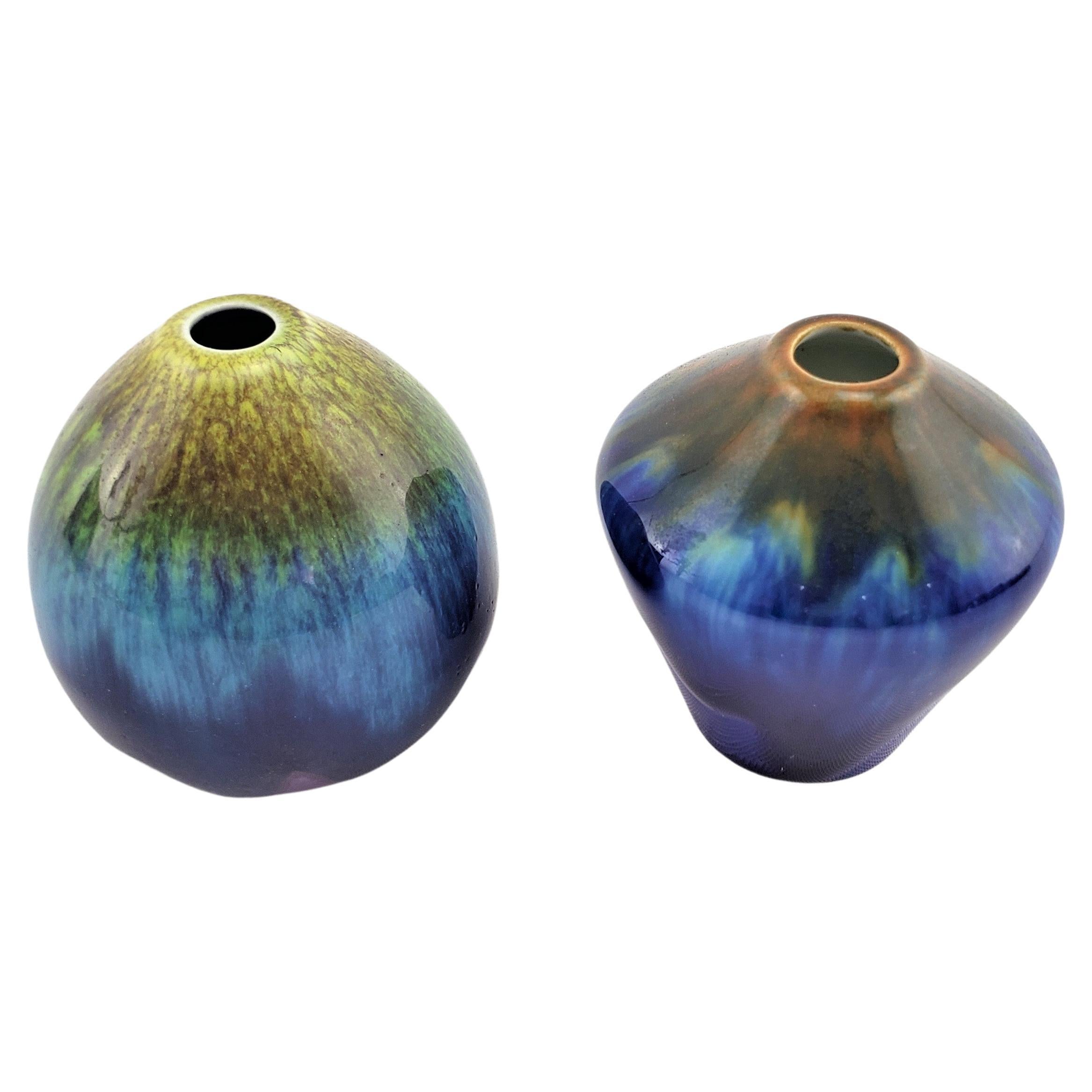 This pair of miniature art pottery vases are unsigned, but being attributed to Berndt Friberg for Gustavsberg of Sweden and date to approximately 1965 and done in the period Mid-Century Modern style. The vases are both two and one have inches in