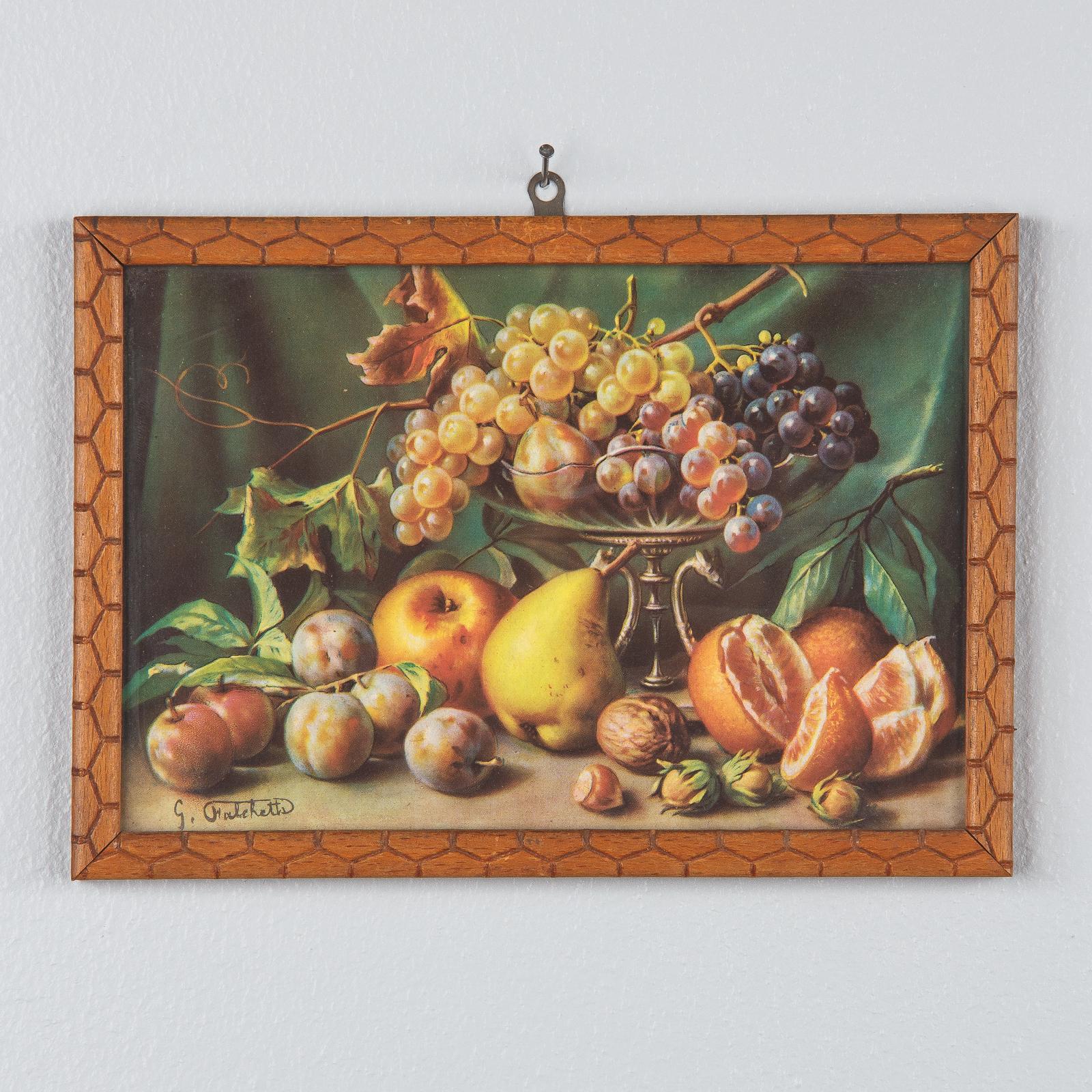 A pair of small framed printed still-life paintings by Giuseppe Falchetti, Italian, circa 1920. Lush still-lives loaded with pears, grapes, peaches, cherries, plums and more framed under glass with carved beechwood frames. Nice quality print with