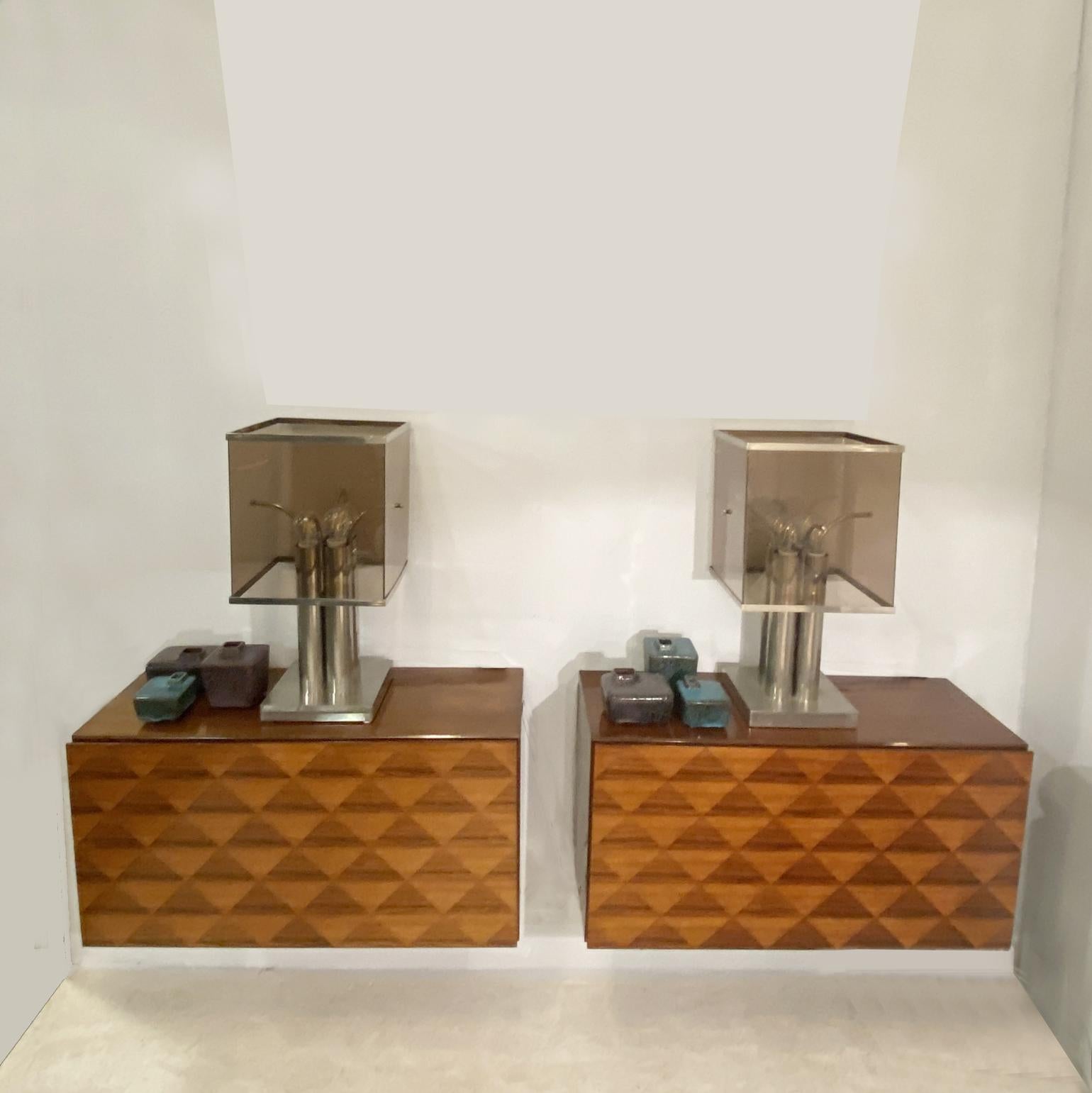 A pair of Mid Century Modern wall hung cabinets by Franz Meyer Mobel, Germany, dated 1968. Both cabinets are veneered with multiple diamond shape designs on the front doors in hardwood veneer.
Very good vintage condition, with the original label