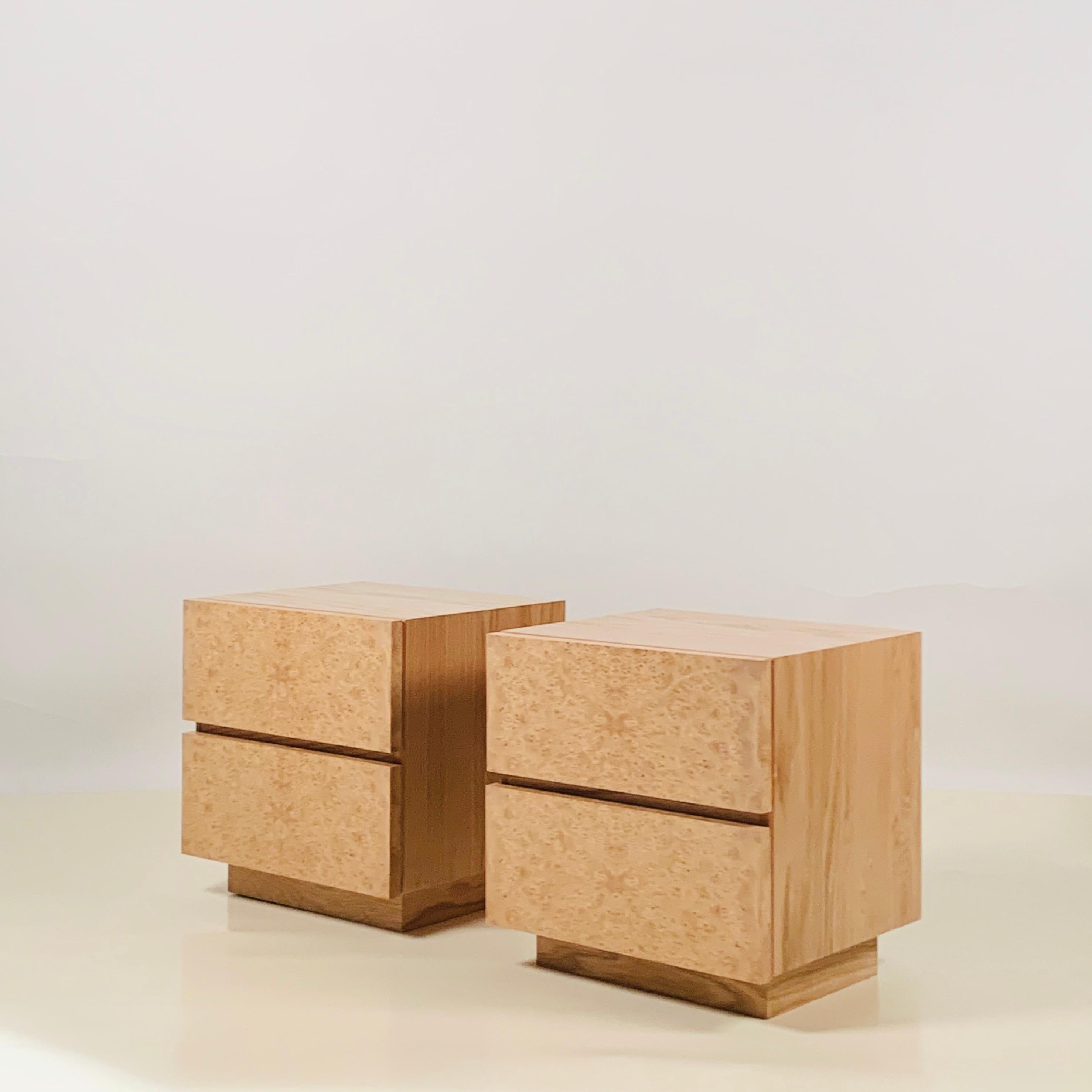 Pair of Minimalist 'Amboine' burl wood nightstands by Design Frères.

Simple, functional design with 2 deep drawers per nightstand.

The bedroom picture is of a similar sized pair.