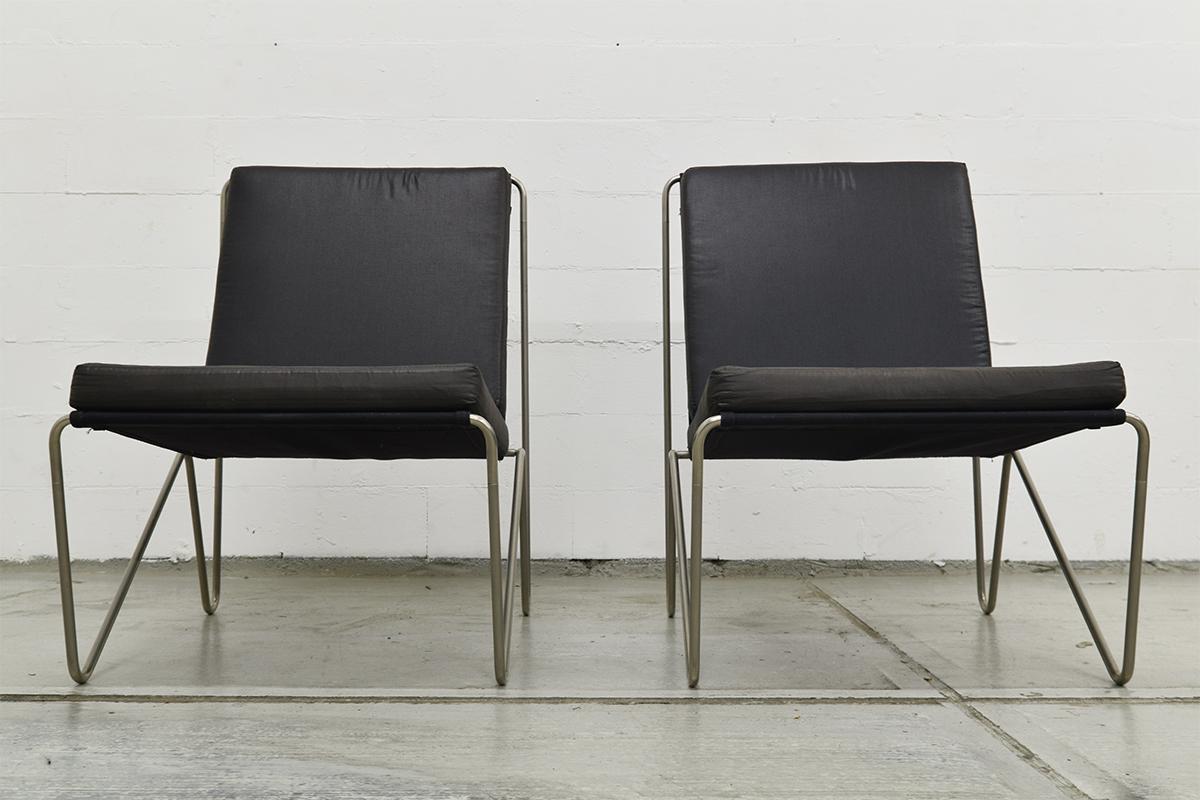 Pair of Minimalistic black Bachelor chairs designed by Verner Panton for the Danish company Fritz Hansen. Produced, circa 1960s. The frame is made of tubular steel and mounted with black canvas and the loose seat and back cushions were reupholstered