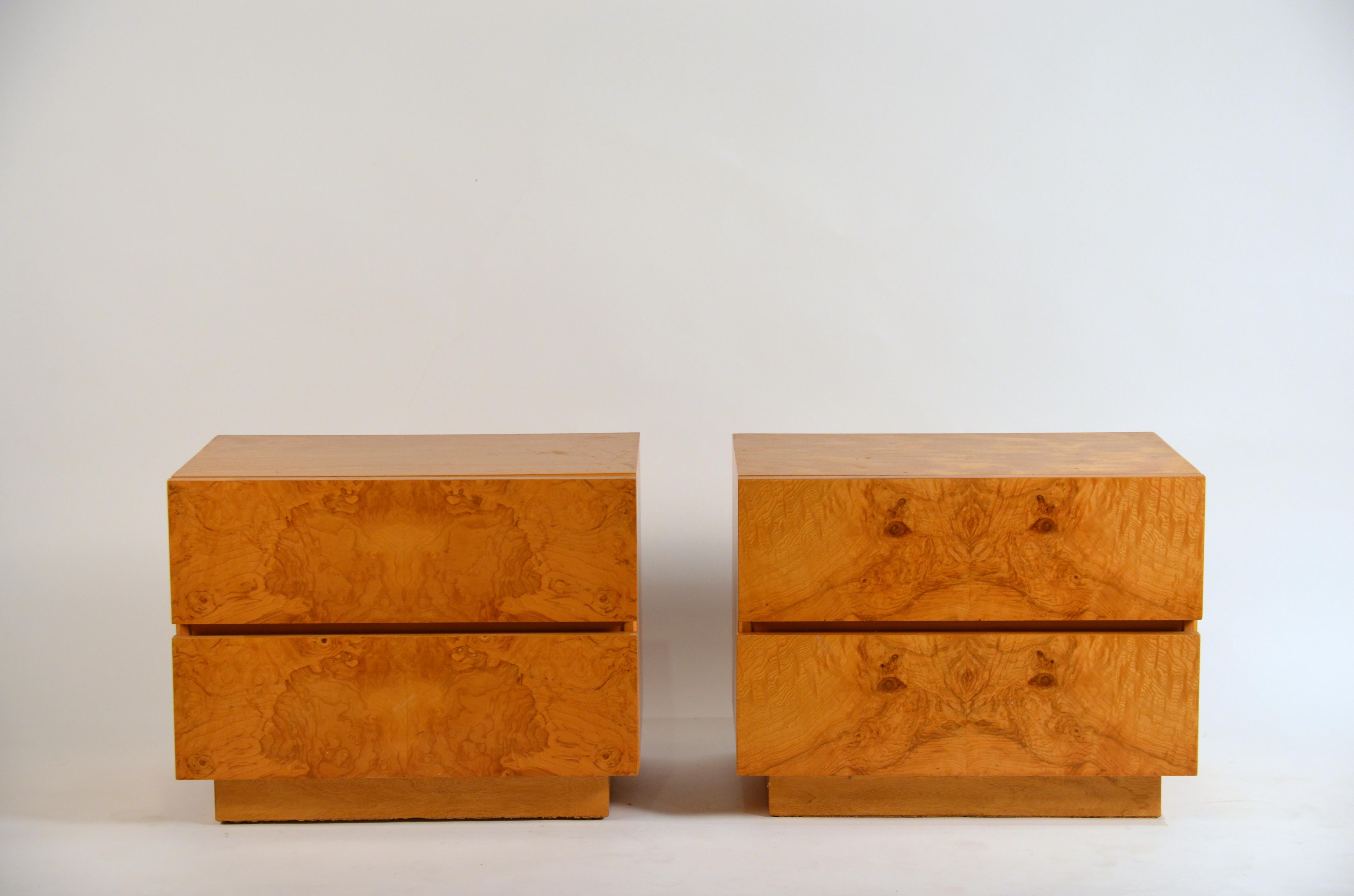 Pair of minimalist 'Amboine' burl wood nightstands by Design Frères.

Simple, functional design with 2 deep drawers per nightstand. Great Rorschach patterns on the of drawer fronts.

The bedroom picture is of a similar sized pair.