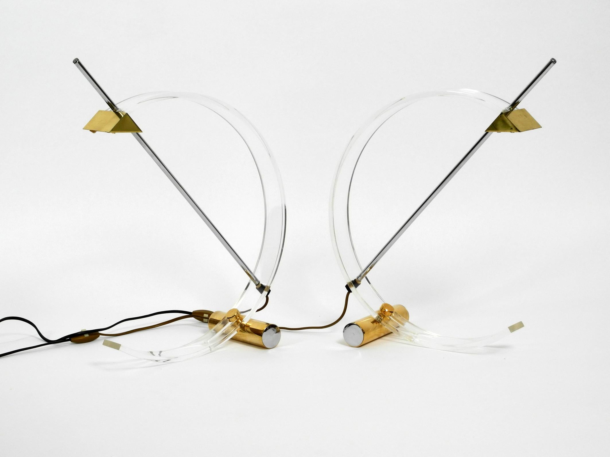 Pair of rare beautiful Postmodern plexiglass halogen table lamps. 
Great minimalistic high quality 1980s design from France.
Thick plexiglass arches with a chrome rod in the middle and adjustable 
heavy weights for stabilization. 
Shades also