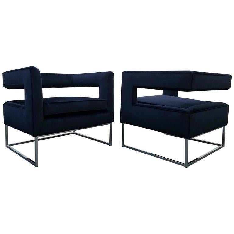 Pair of stunning lounge chairs. Features a floating cut-out backrest and chromed steel base. Upholstered in blue velvet. These chairs would complement any Regency, Mid-Century Modern, or eclectic decor.