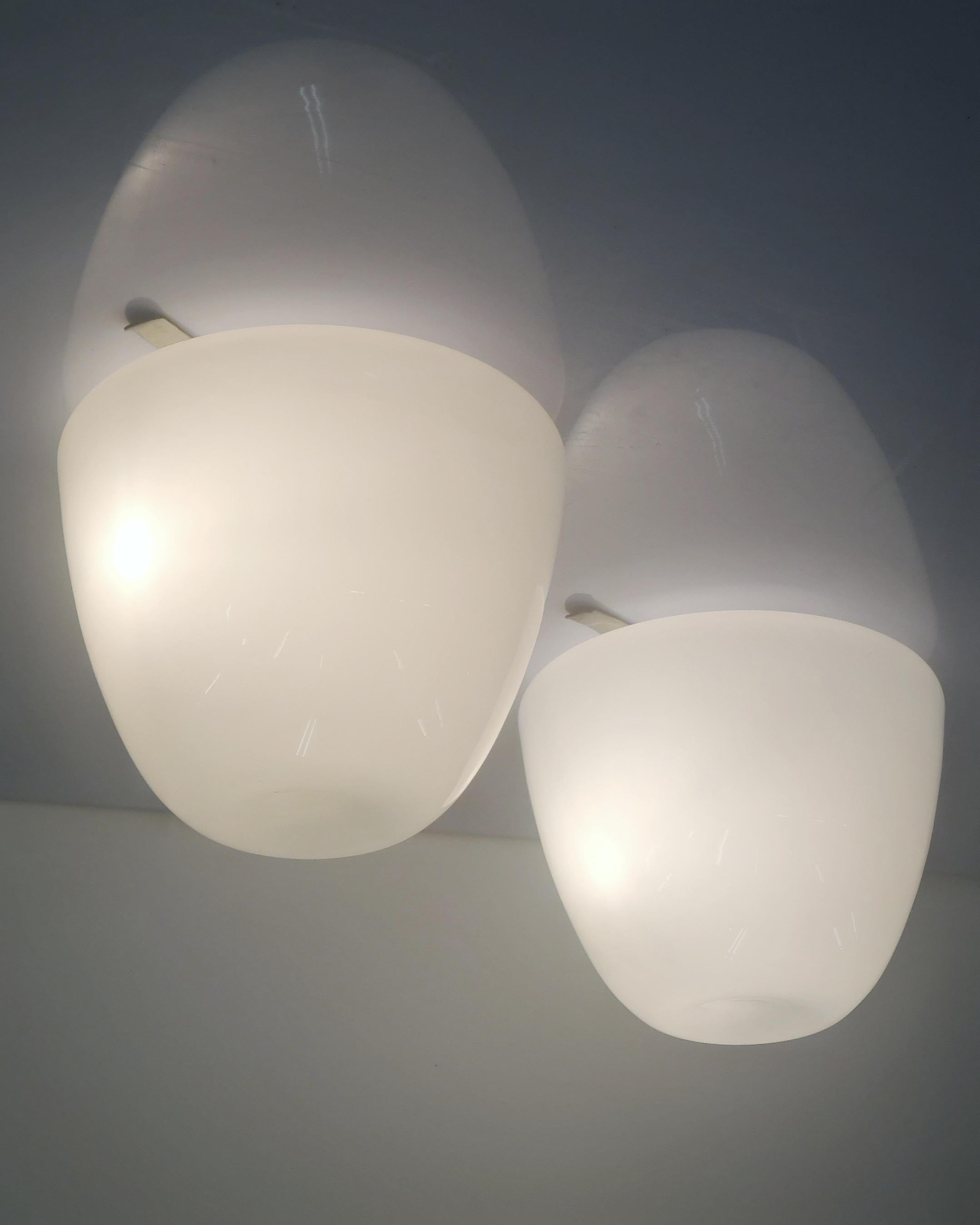 An elegant pair of ceiling lamps model 80112/80115, designed by Gunnel Nyman and manufactured by Idman in Finland in the 1950s. This very minimal design fits easily into any interior. As with a lot of Scandinavian design the beauty of these lamps
