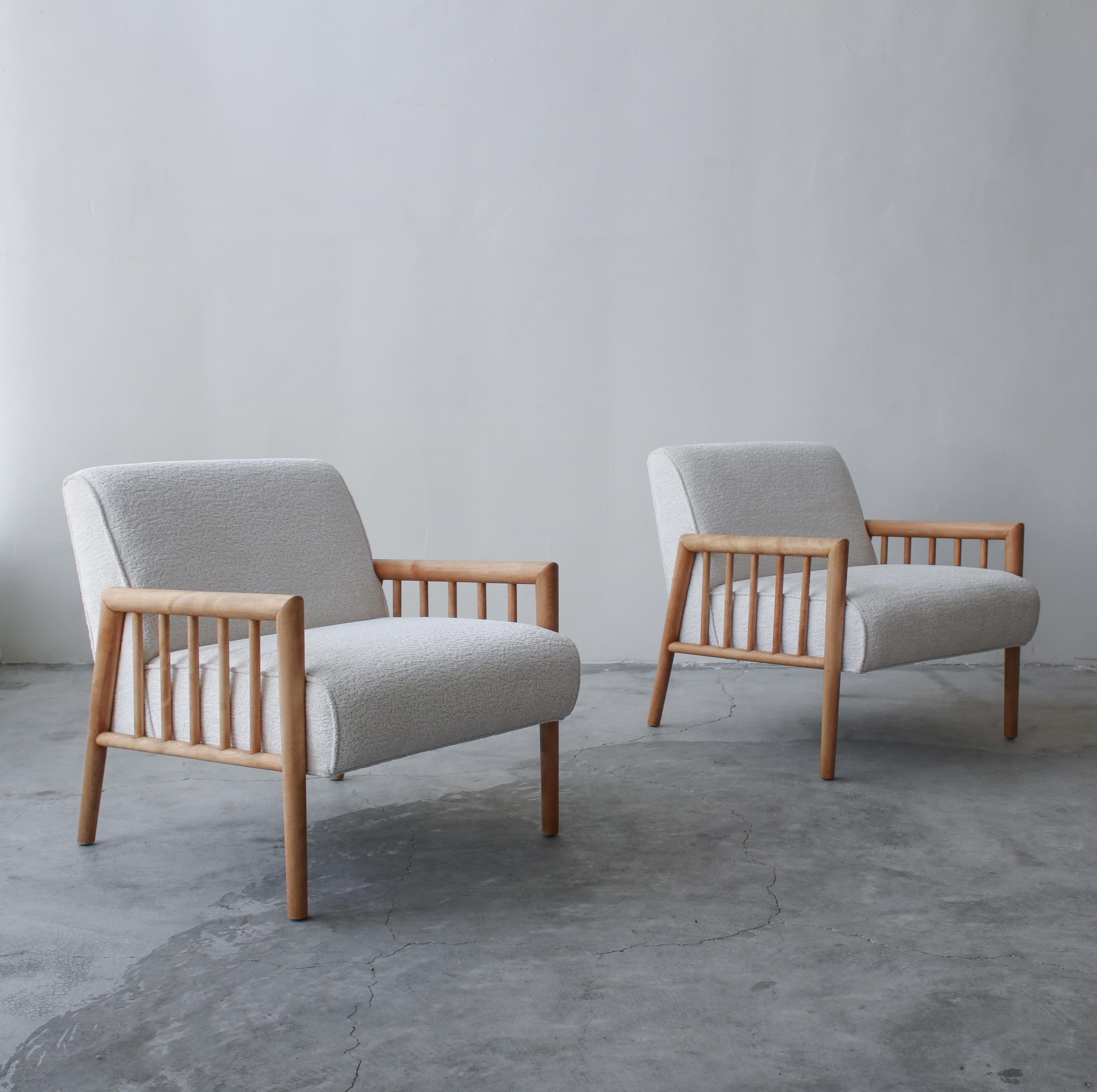 This is an absolutely gorgeous pair of midcentury lounge chairs designed by Leslie Diamond for Conant Ball. Absolutely gorgeous lines, constructed of solid wood that has been left au naturel, combined with an off-white, bouclé style fabric this is a