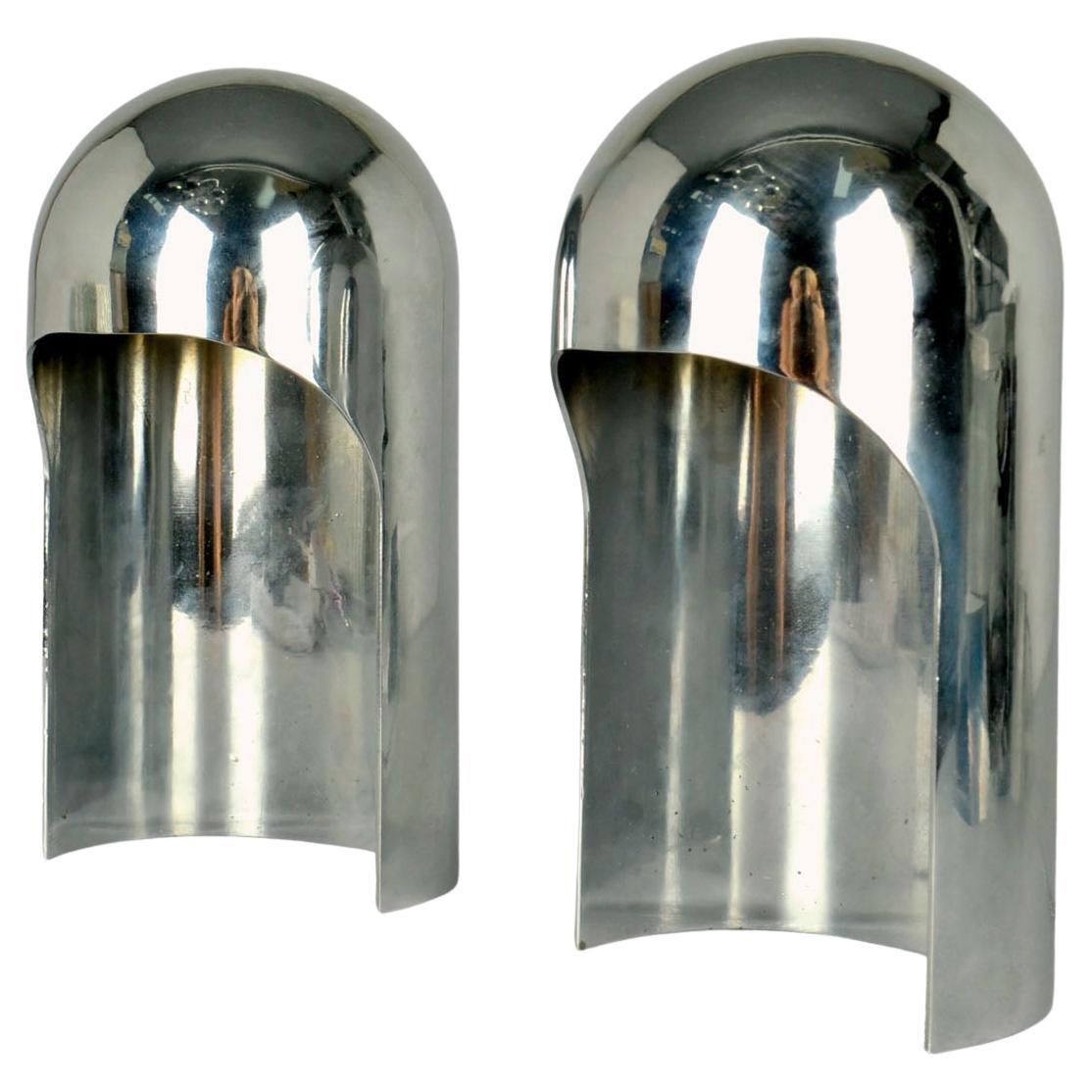 Pair of Minimal polished aluminum dome table lamps, Italy 1960's. These self-supporting hooded structures resembles the curved hollow upper half of a sphere. The sculptural arch shaped lamps are cast in one piece and stand on a curved base. The form