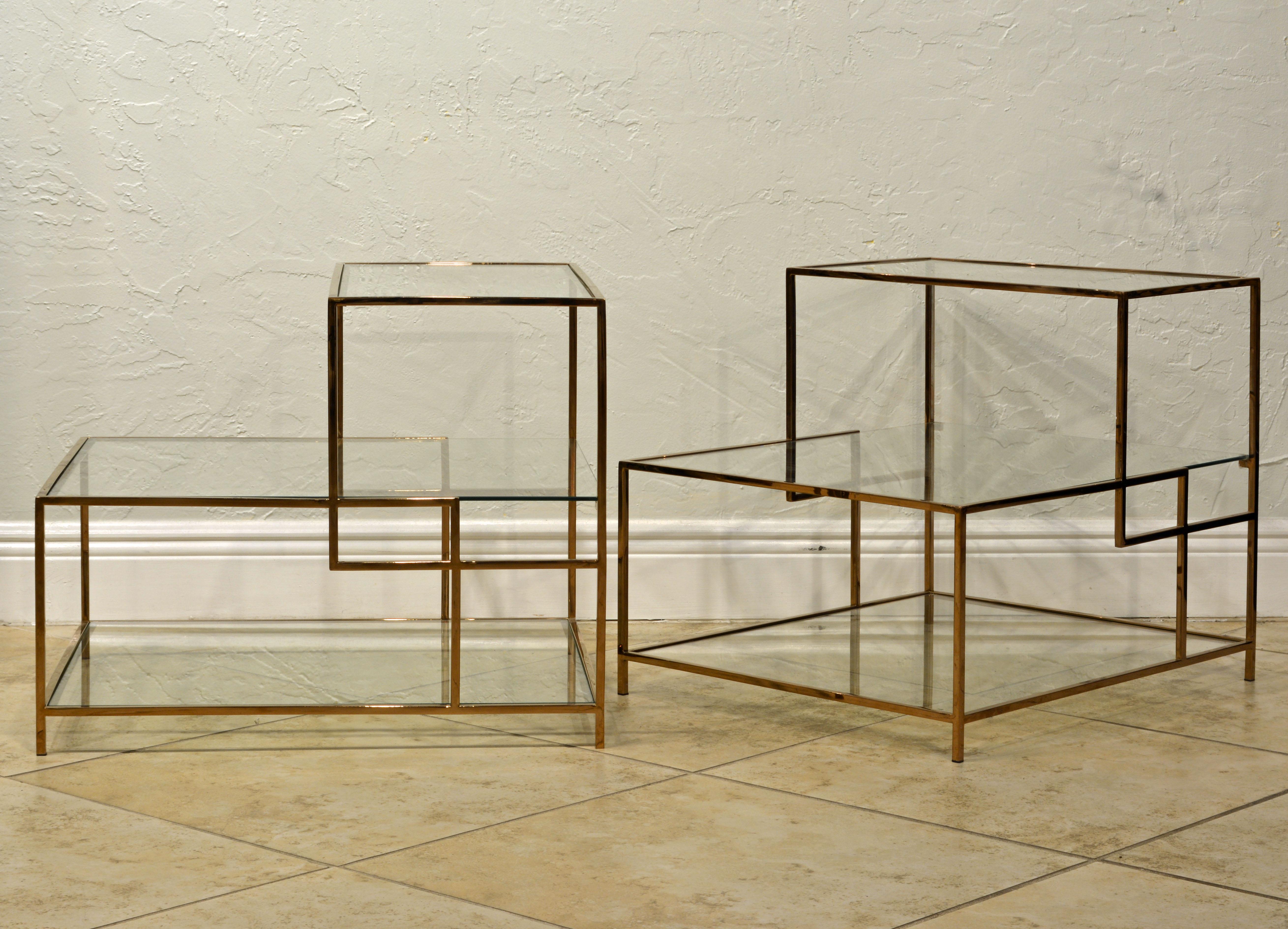 These end tables feature an elegant Minimalist design reminiscent of Piet Mondrian's art. The frames are made of solid brass with beautiful sleek craftsmanship. The three glass surface tiers offer great options for placement of lamps, magazines and