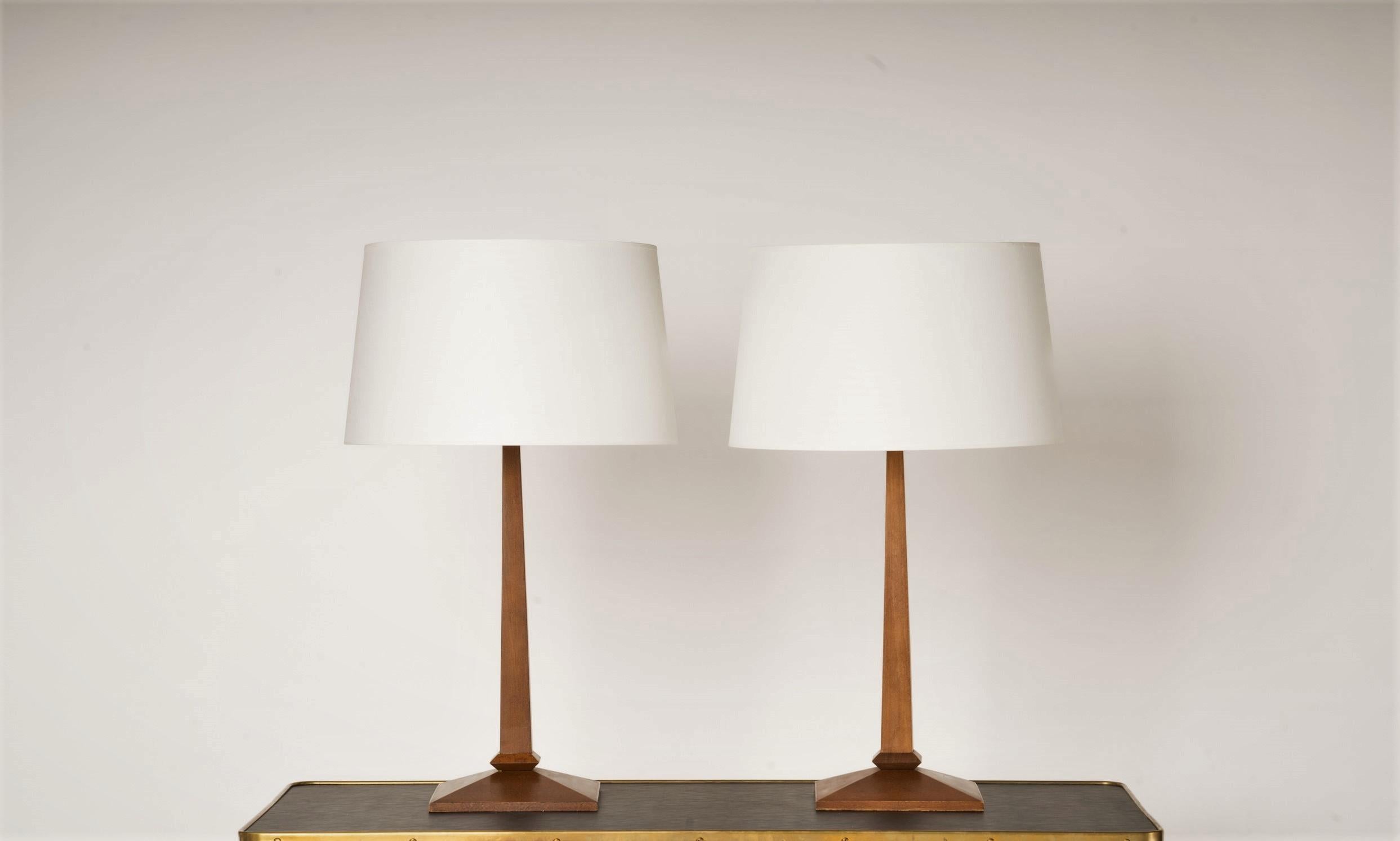 Sleek minimalist design wooden table lamp. European socket and wiring. 
Minor marking on bases. One of the lamp's pole is slightly lighter than on the other lamp.
These lamps will ship from France and can be returned to either France or to a LIC NY