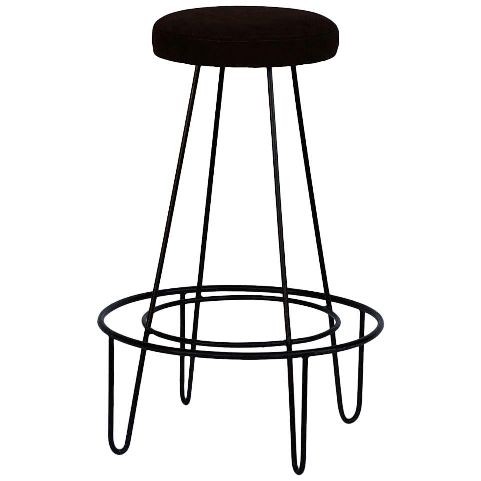 Pair of minimalist bar stools with brown suede seats.