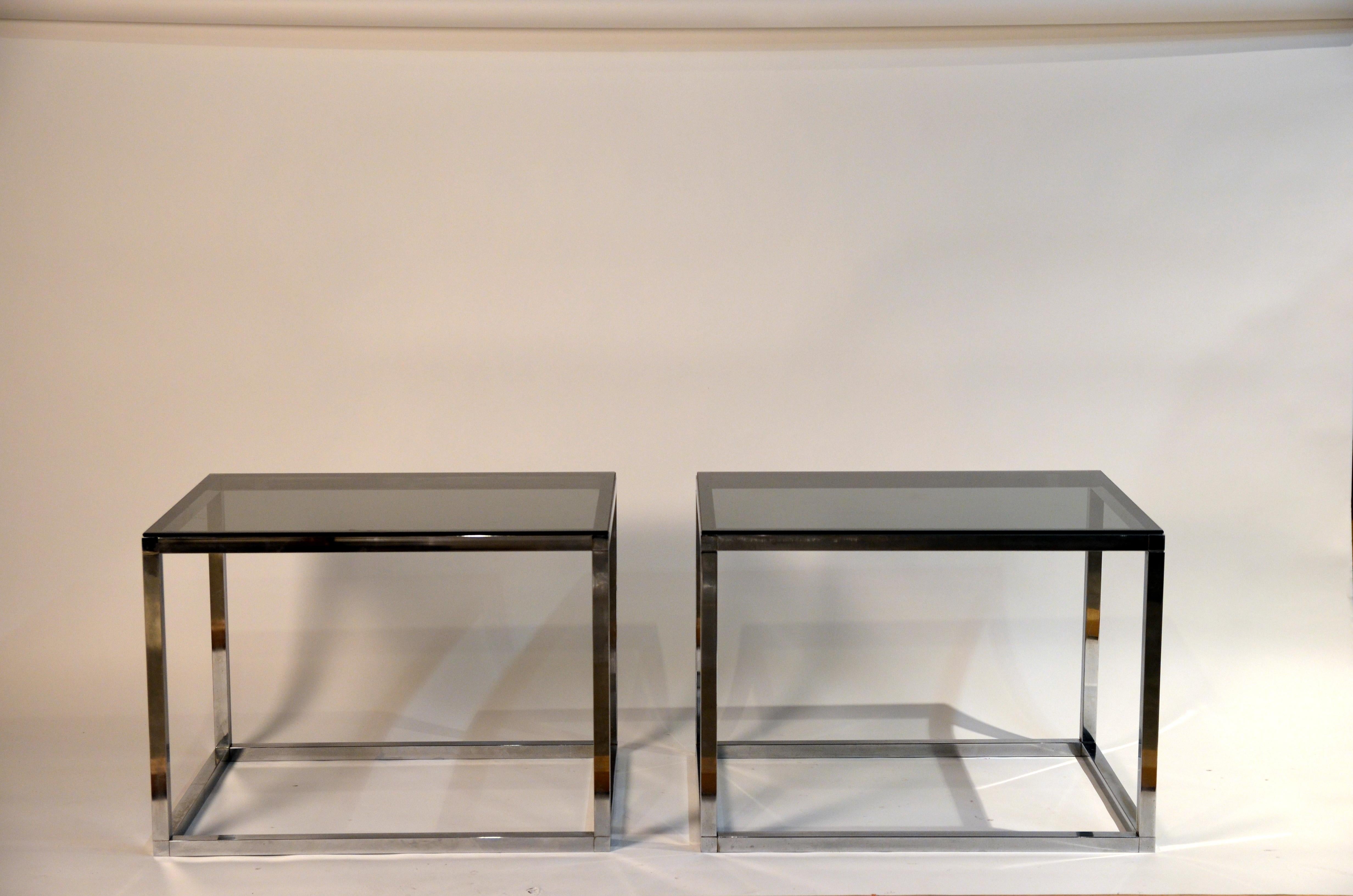 Pair of minimalistic chrome and smoked glass side or sofa end tables. Large sections; quality construction, chic pared down design.
