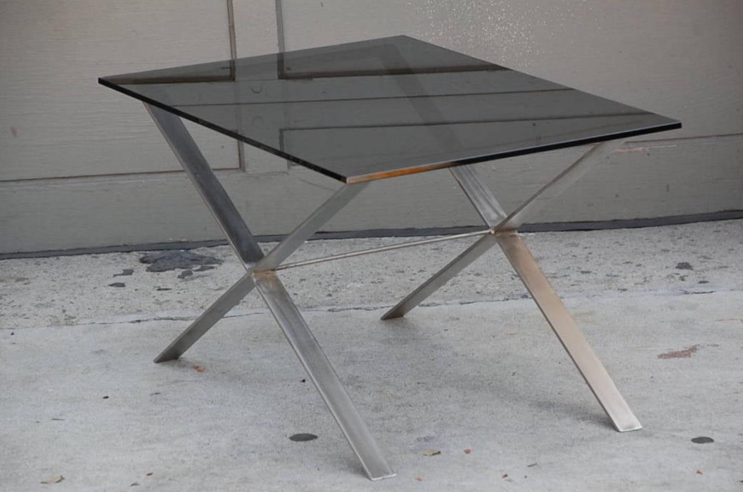 Pair of minimalistic stainless steel and glass side tables.