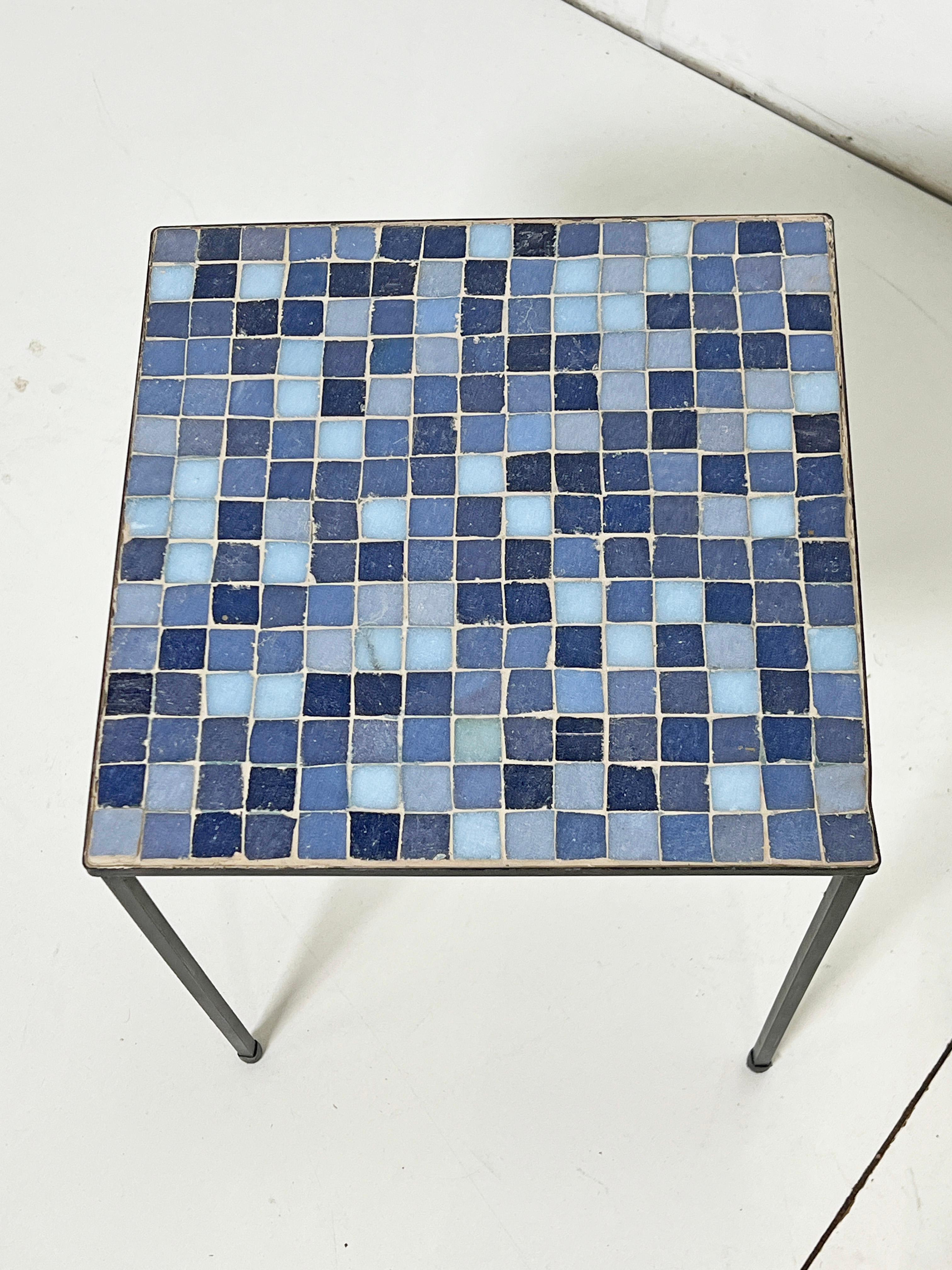 A pair of Italian side tables with Murano glass inset tiles. This design is often associated with the American importer Raymor, which exported goods from various Scandinavian and Italian factories to the United States from the 1940s until 1980. This