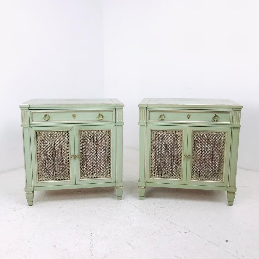 Fabulous pair of 1970s transitional nightstands in mint green. Crafted from high-quality materials and built to last, these side tables feature 1 drawer and 1 storage space behind two grated doors. Good vintage condition with some cosmetic