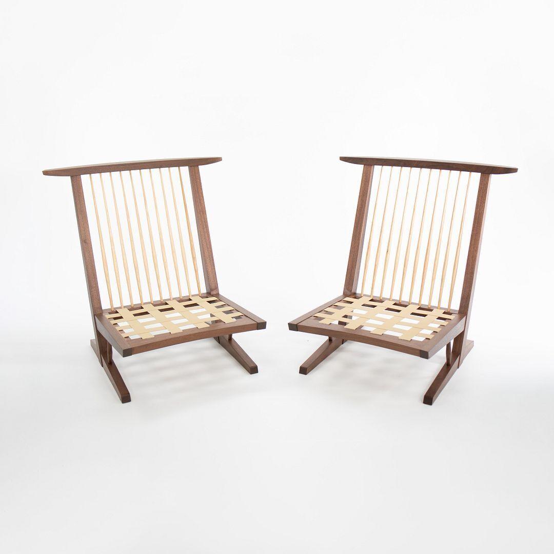 We present this pair of 2022 production Conoid cushion chairs by Mira Nakashima and the Nakashima Woodworkers. The Conoid cushion chair design was introduced in 1961 by Mira's father George and named after the Conoid Studio on their campus of