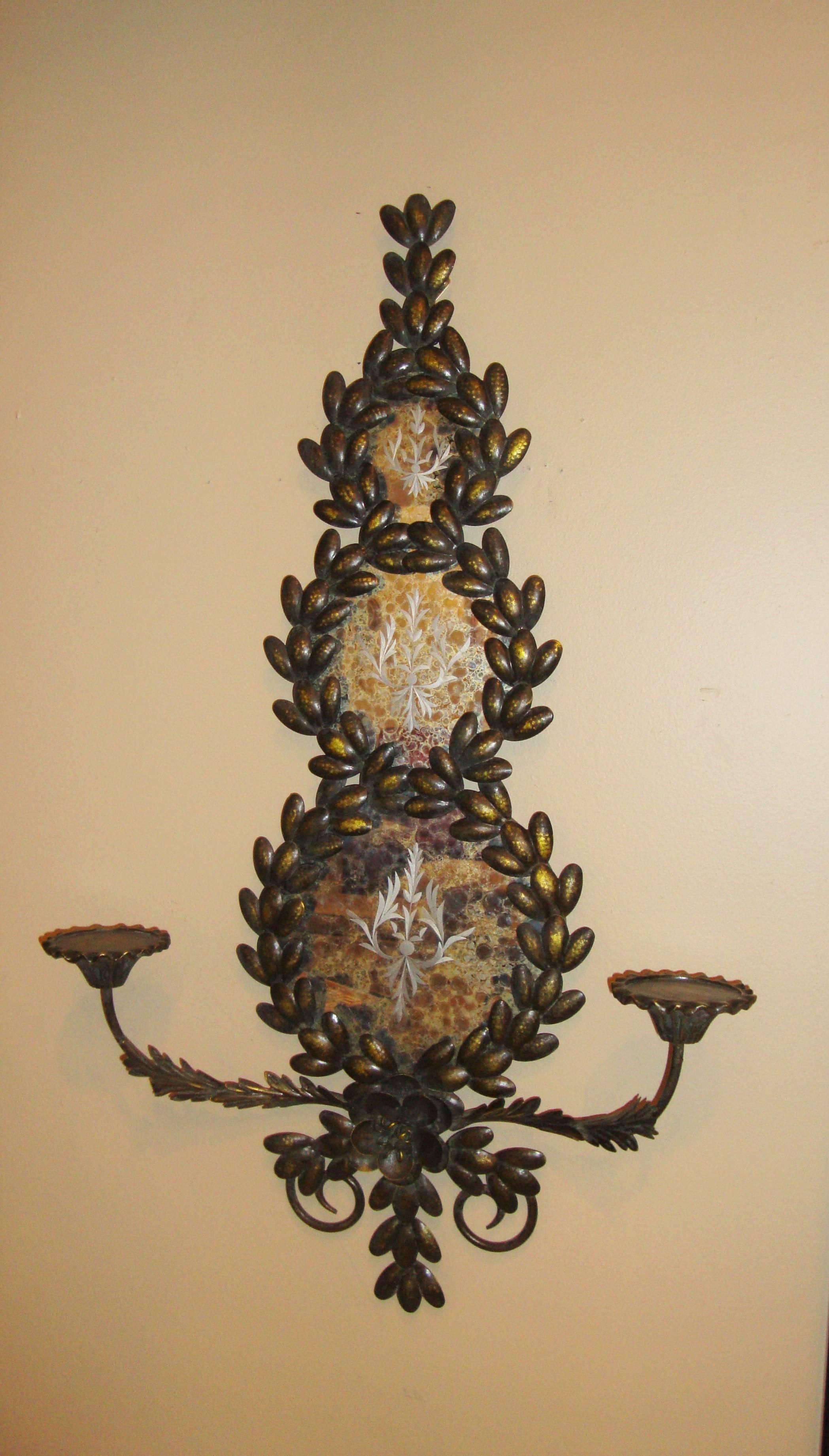 Pair of mirrored and candle arm wall sconces. With round mirrors and metal candleholders set in a fame of leaf and vines with a large center rose on the bottom.