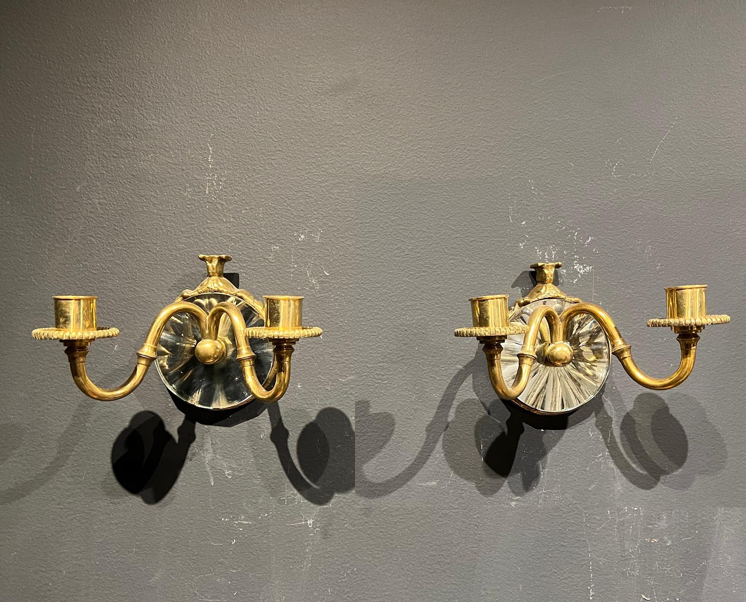 A pair of beveled mirror backplate sconces with two lights, circa 1920s. In very good vintage condition.

Dealer: G302YP