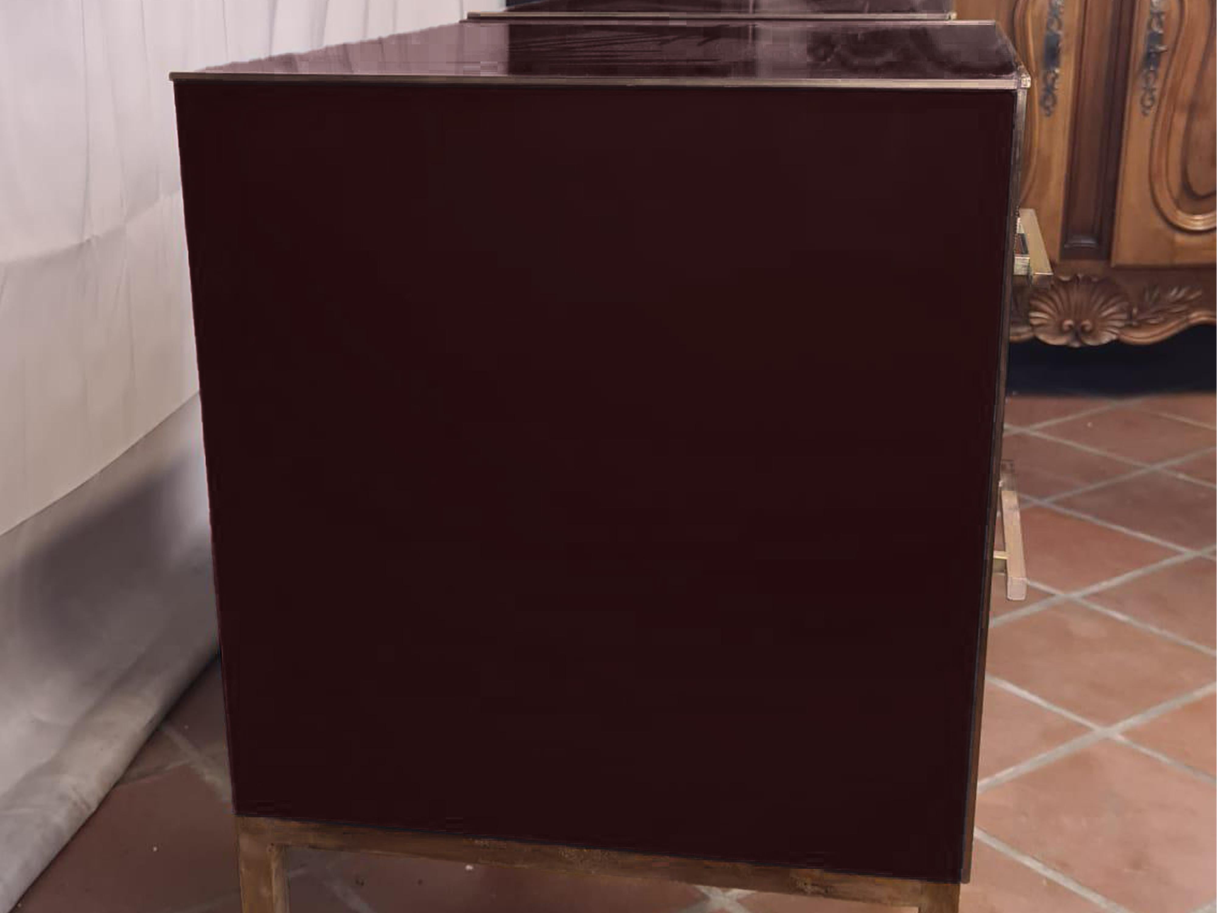 This pair of dark red mirrored glass nightstands embodies the elegance of 1950s design with a contemporary twist. 

Made of solid birch, each nightstand features dark red mirrored glass surfaces that beautifully reflect light, enhancing the