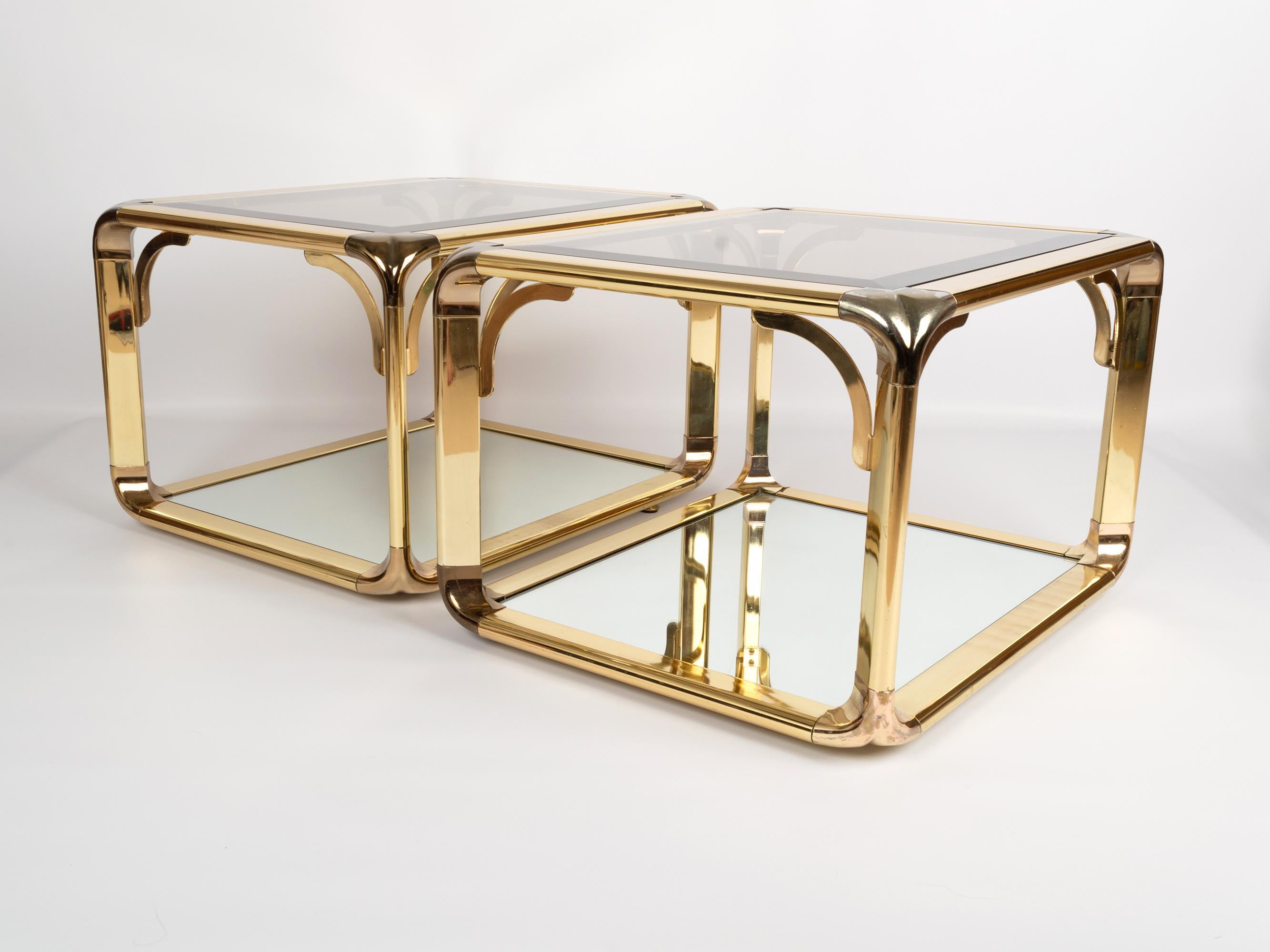 Pair of mirrored gold chrome two-tier end tables by Belgo Chrome, Belgium, circa 1970. Smoked glass top with a mirrored lower tier.
In excellent vintage condition commensurate of age.