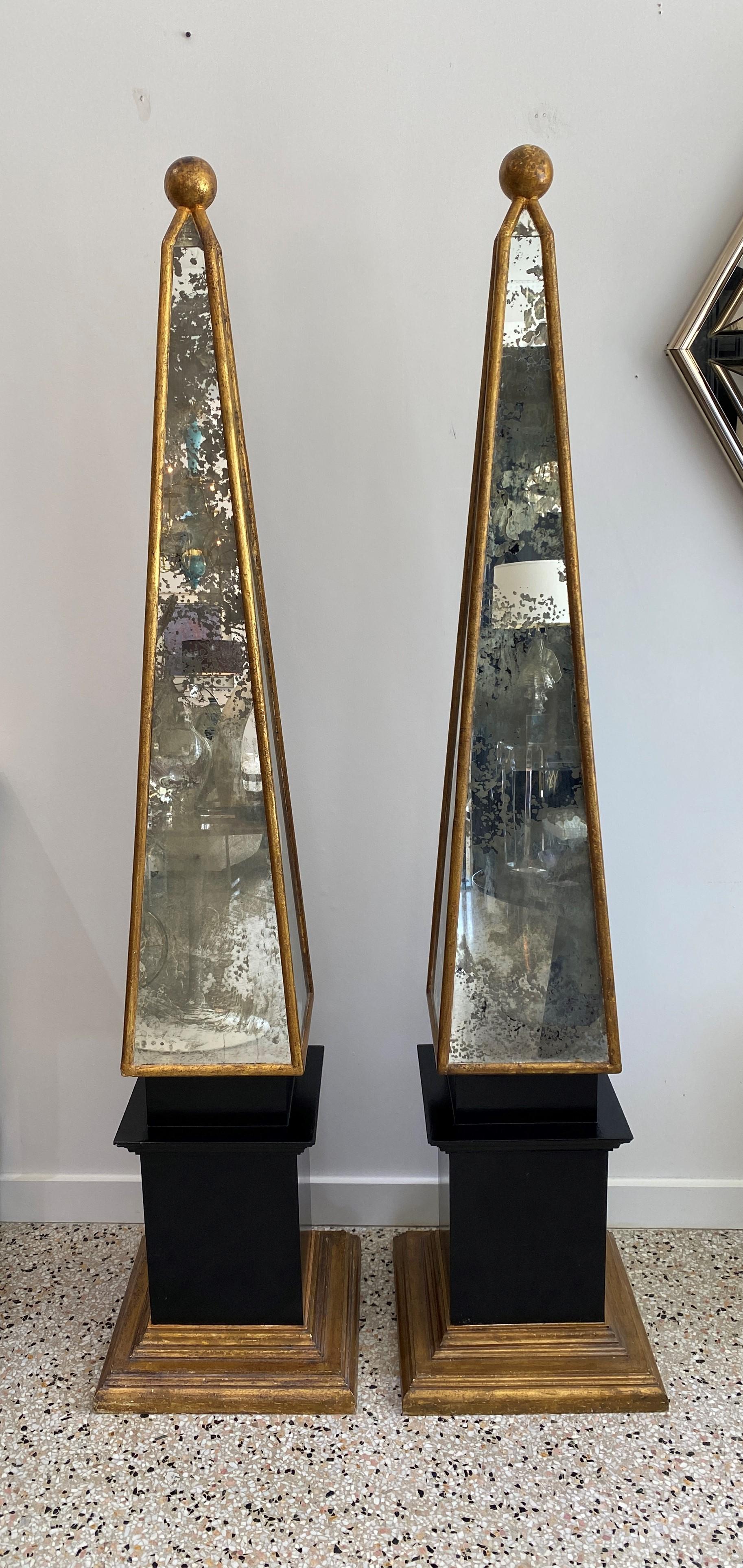 This large scale pair of 1930s Italian obelisk will make a definite statement with their classic form and use of antiqued mirror and Florentine gold finish.