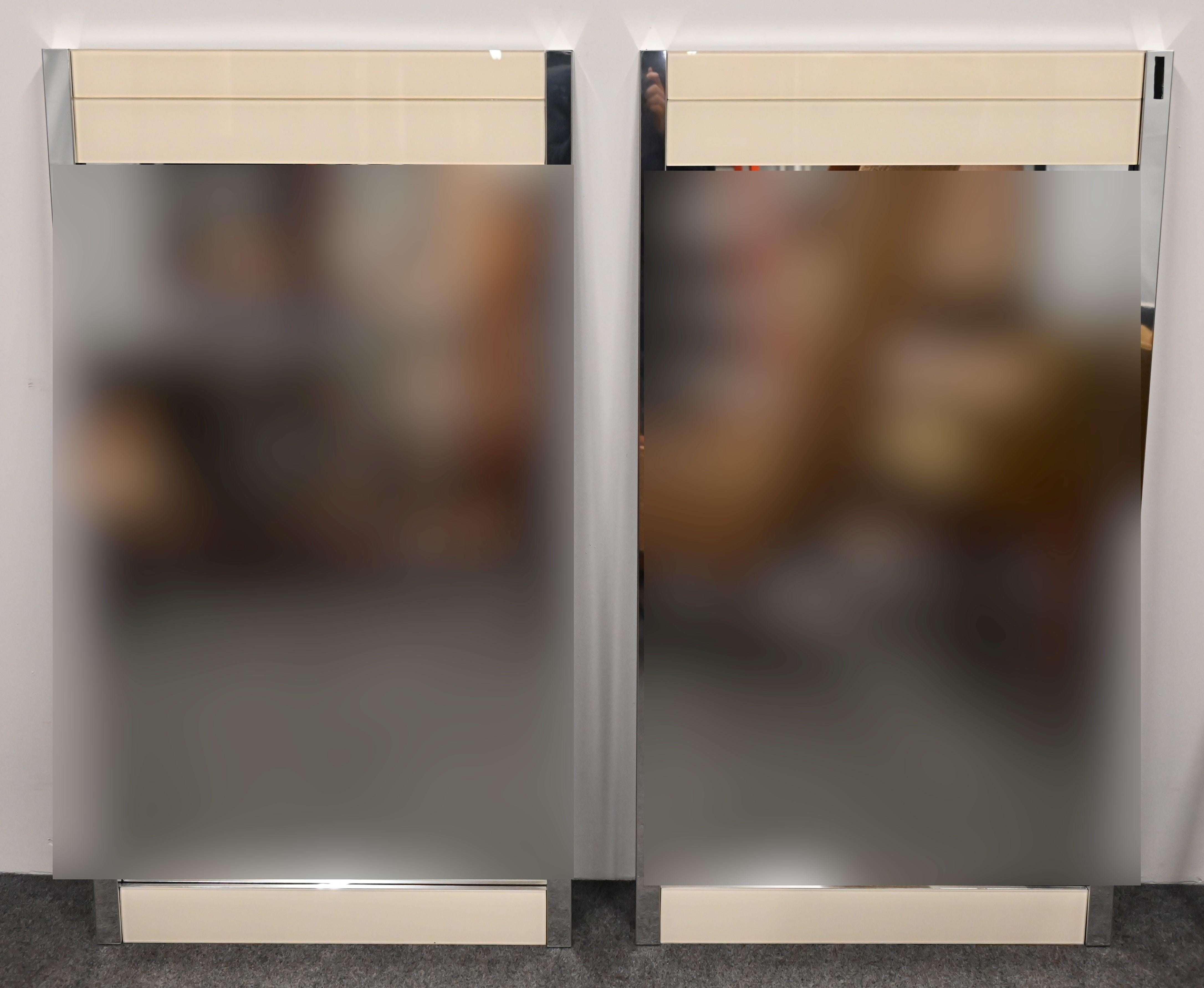 A great pair of Chrome and Glass Mirrors with creme mirror accents by Ello. The mirrors are a great minimalist look for that simple streamlined interior. They would work in any Mid-Century Modern or Contemporary home. The mirrors are in very good