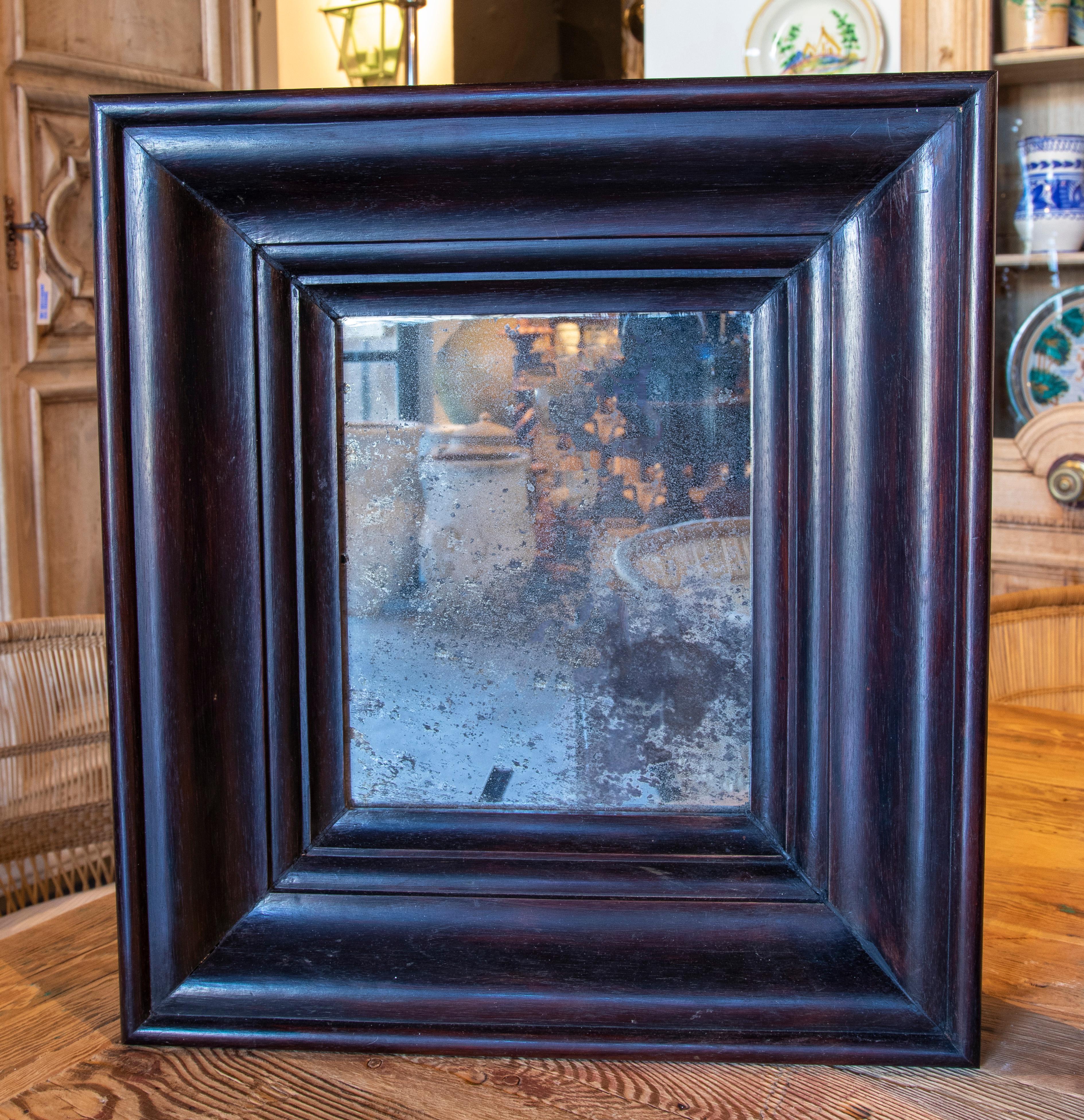 Pair of mirrors in dark rosewood with antique glass.
