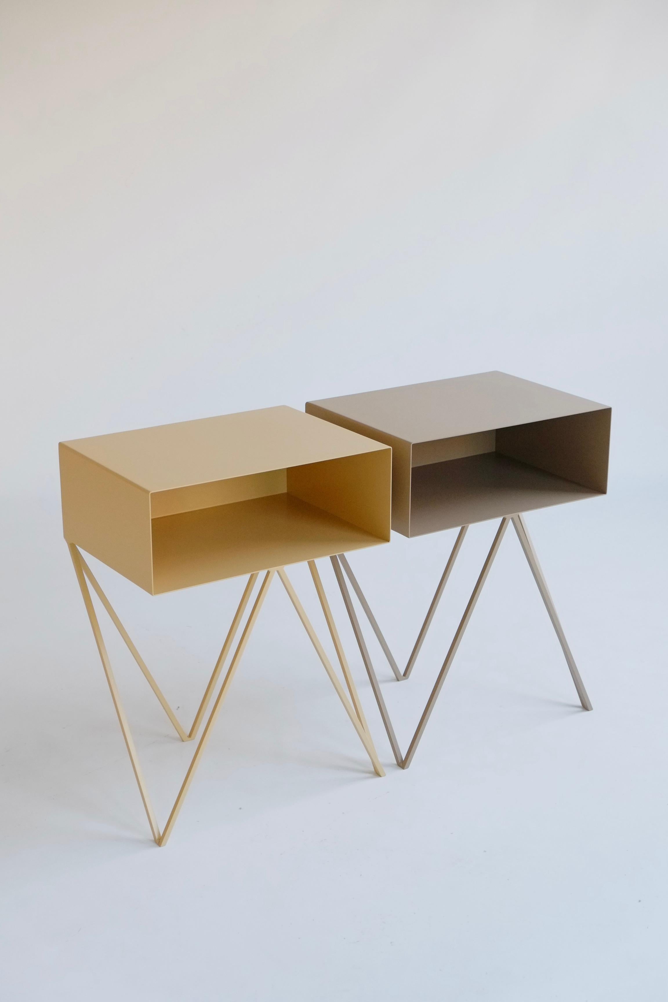 A beautiful pair of mismatched butternut and coco Robot bedside tables. The Robot side table features an open shelf on zig zag legs. A fun and functional design made of solid steel, one is powder-coated in butternut and the other in coco. The clean