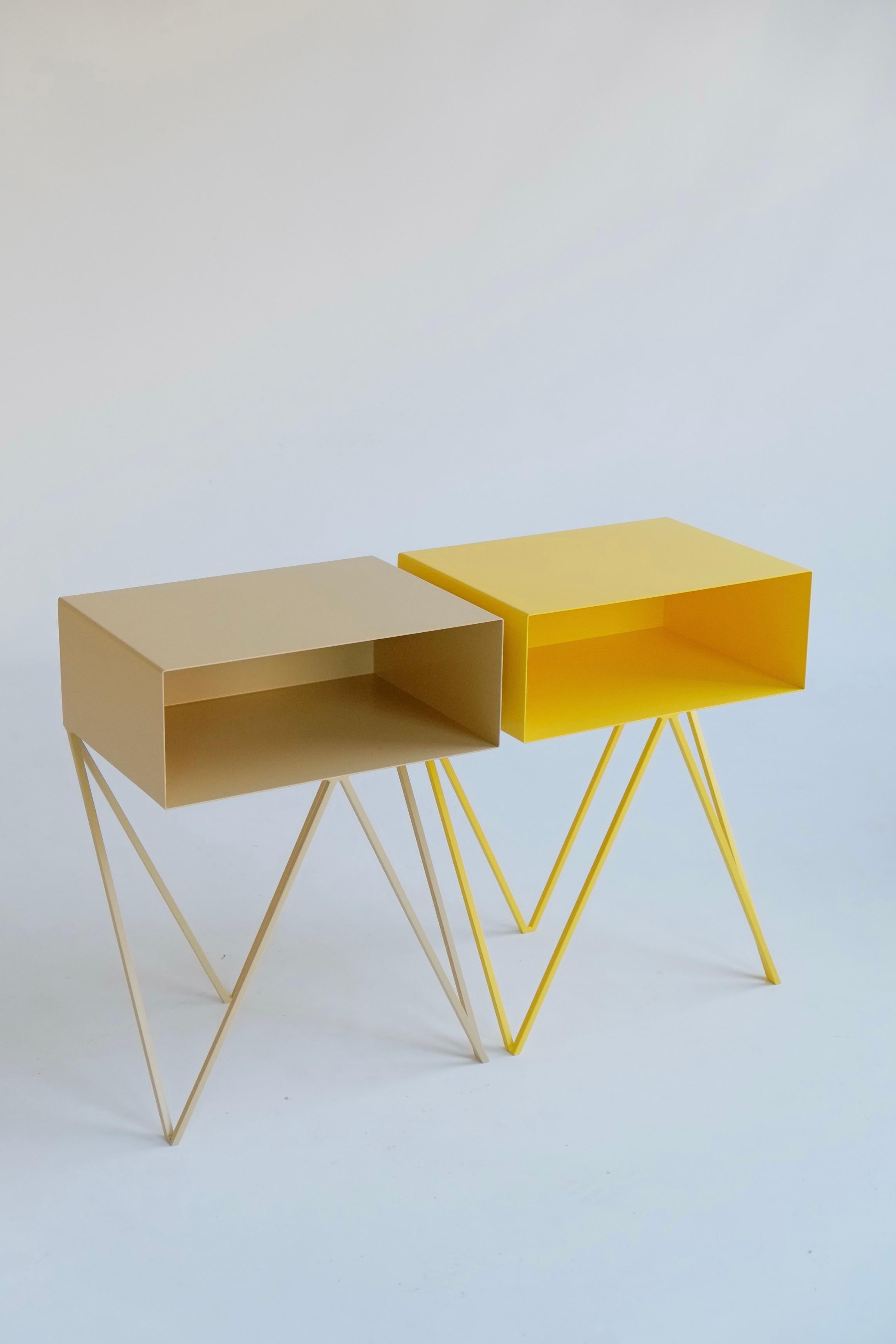 A beautiful pair of mismatched yellow and butternut Robot bedside tables. The Robot side table features an open shelf on zig zag legs. A fun and functional design made of solid steel, one is powder-coated in yellow and the other in butternut. The