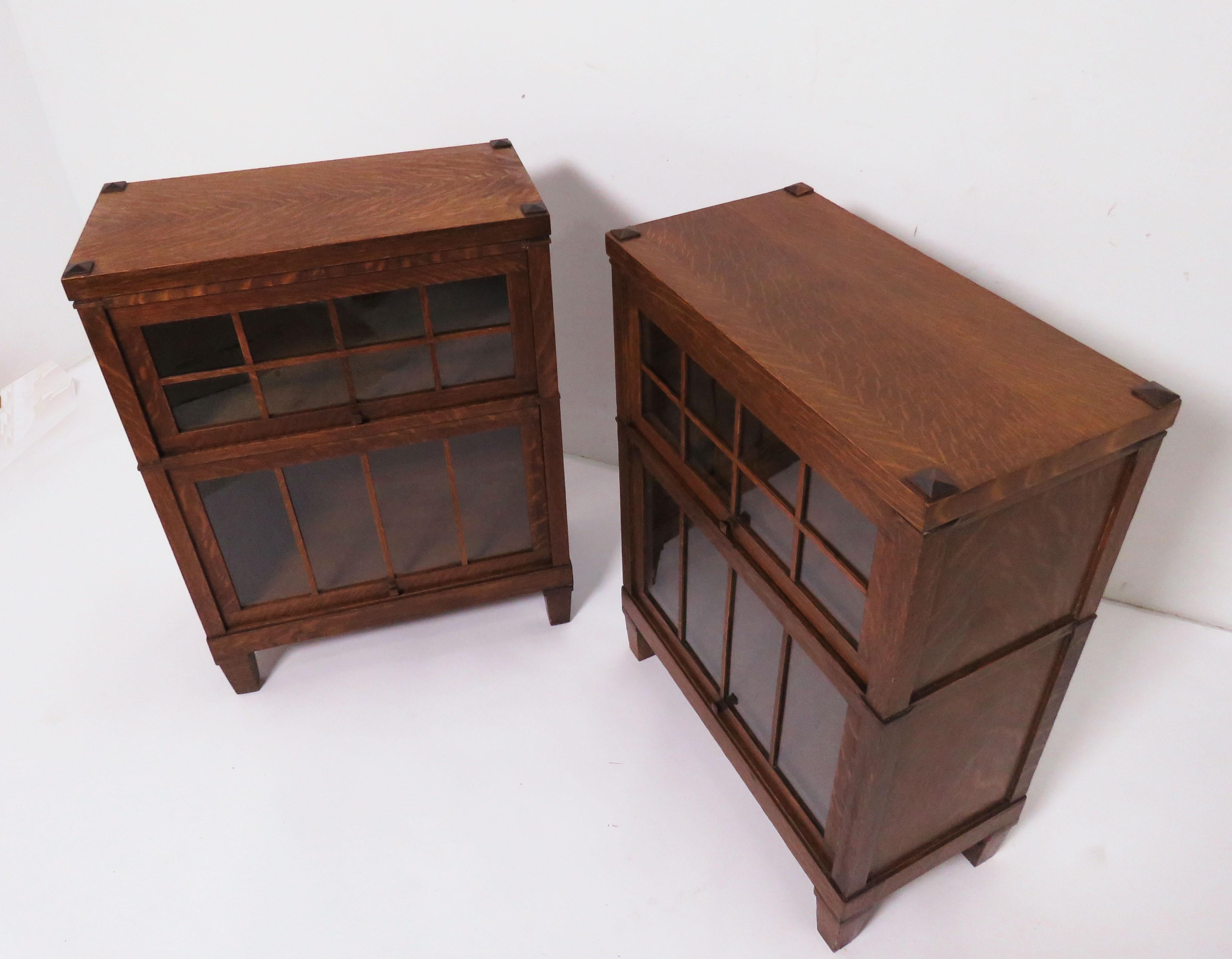 A pair of Mission style barrister cabinets in quartersawn oak by the Macey Co., of Grand Rapids, Wi., circa 1910. These are the rare, narrow size, complete with original bases and lids, well suited for use as end or side cabinets in an Arts & Crafts