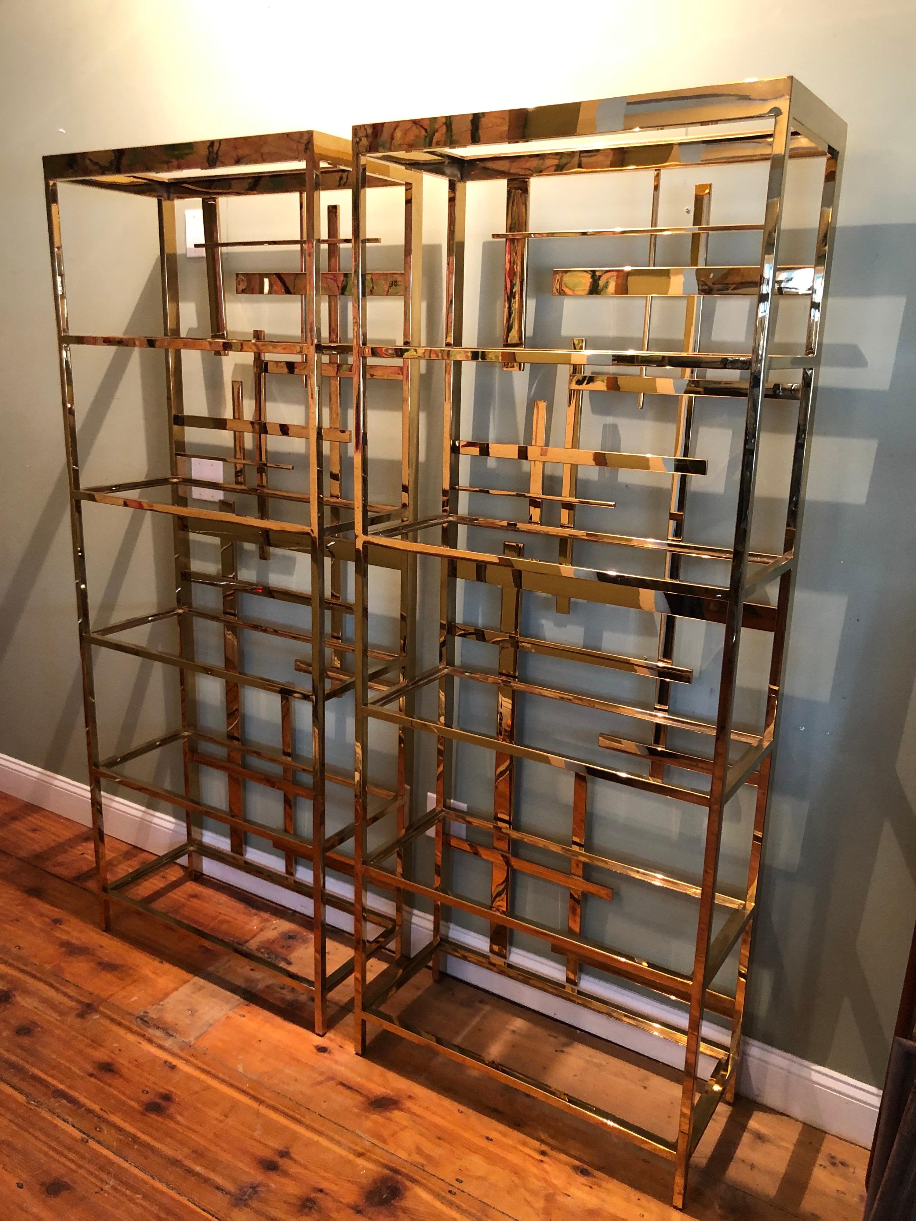 Pair of Mitchell Gold and Bob Williams brass étagères. These étagères are in themselves a piece of sculpture and would dramatically enhance any room. They come with five glass shelves each. Glass not shown but included.
Great for storage of books