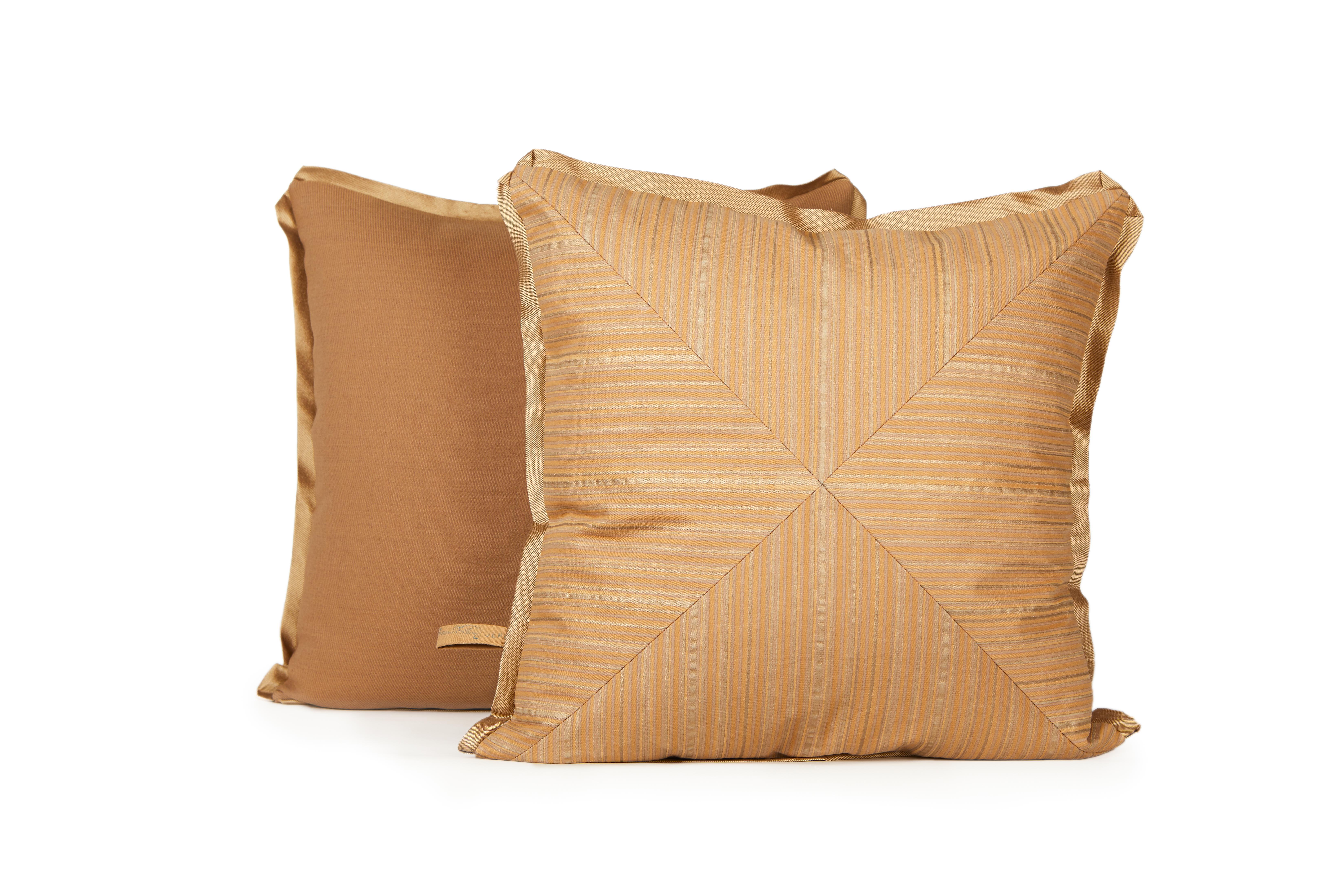 A pair of mitered Fortuny fabric cushions in the Malmaison pattern in tan beige and gold. Silk blend backing material and silk bias edging, brown and gold color way with tan stripe motif. The pattern is named after the former residence of the