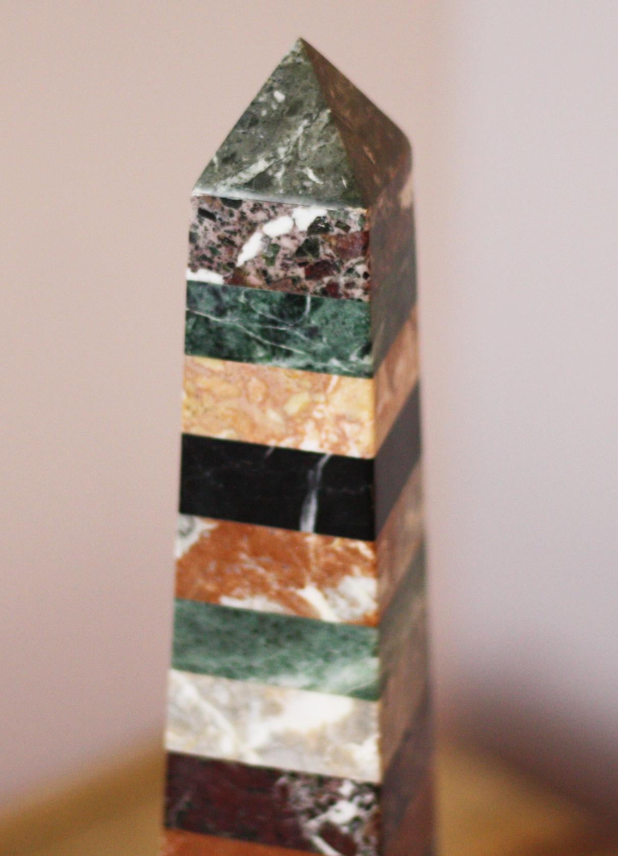 Smart pair of multi-marble obelisks with decorative ormolu bases.