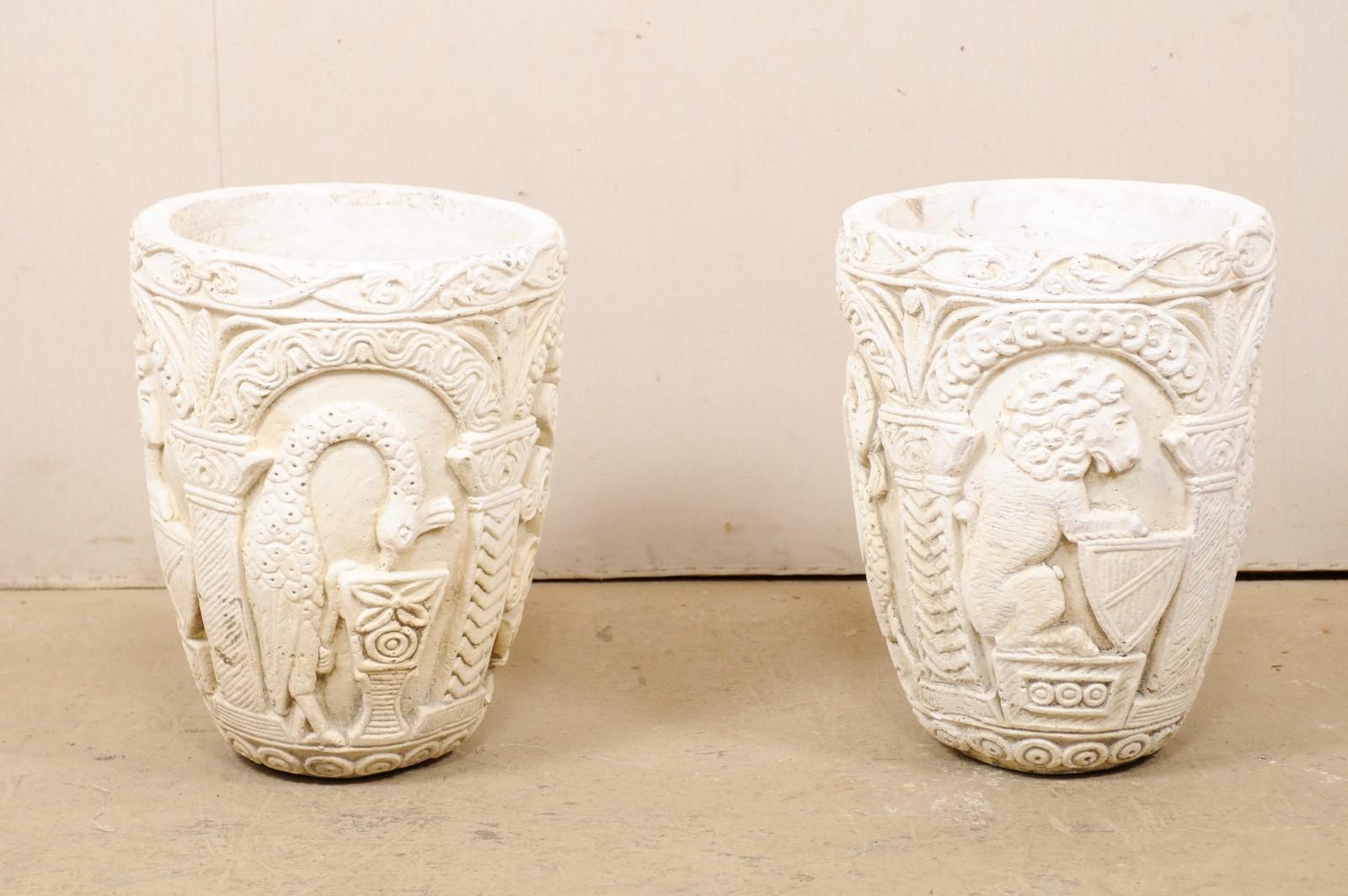 A very special pair of Mizner style, beautifully decorated cast stone outdoor planters from the mid-20th century. This pair of vintage American planters have been created from cast-stone and artfully decorated about the exterior with various