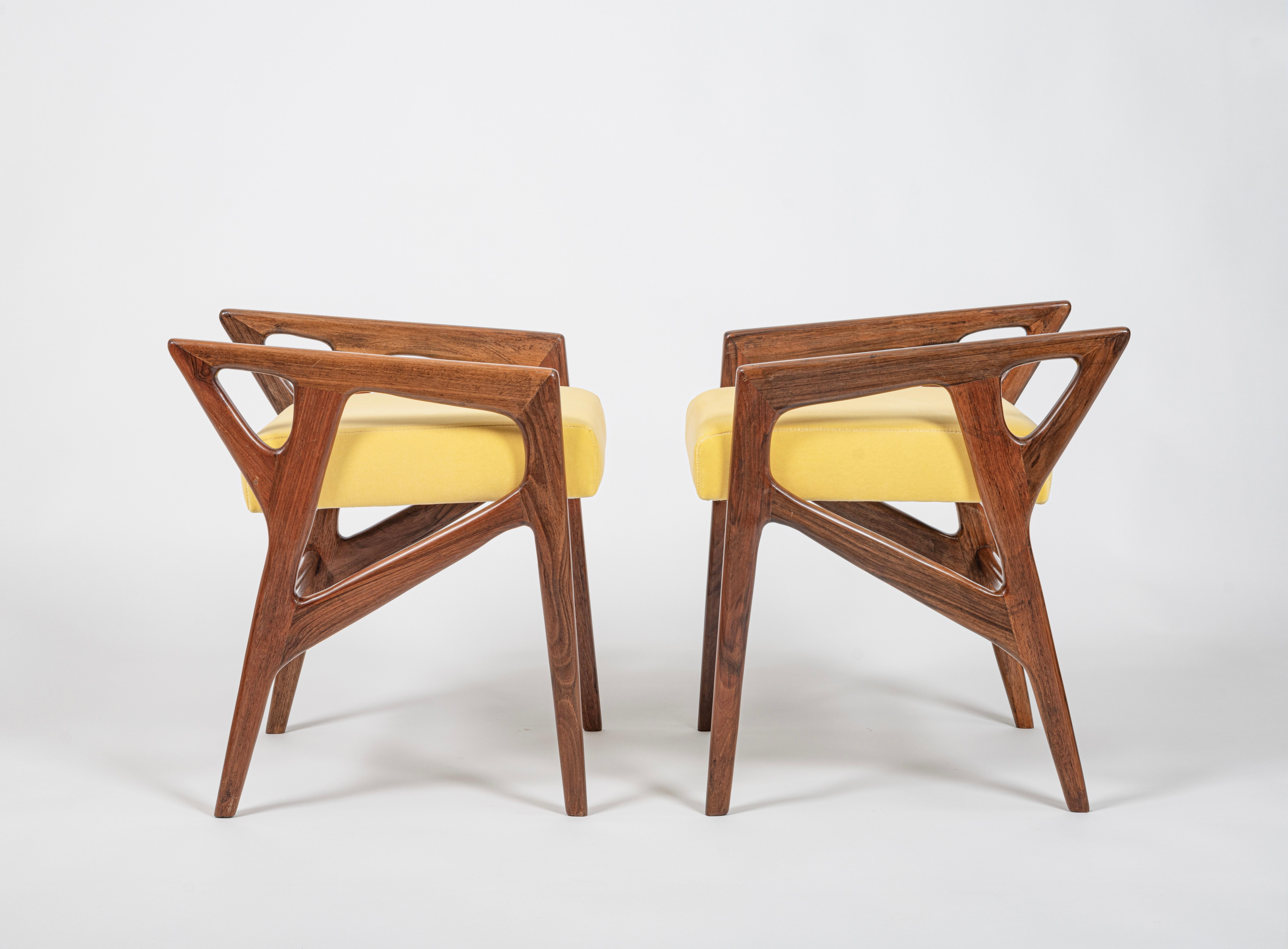 A beautiful pair of Model '687' walnut stools / ottomans designed by Gio Ponti for Cassina, Italy, c.1953. With great sculptural lines and elegant tapered legs, these stools will make a great addition to any room. Seats have been re-upholstered with